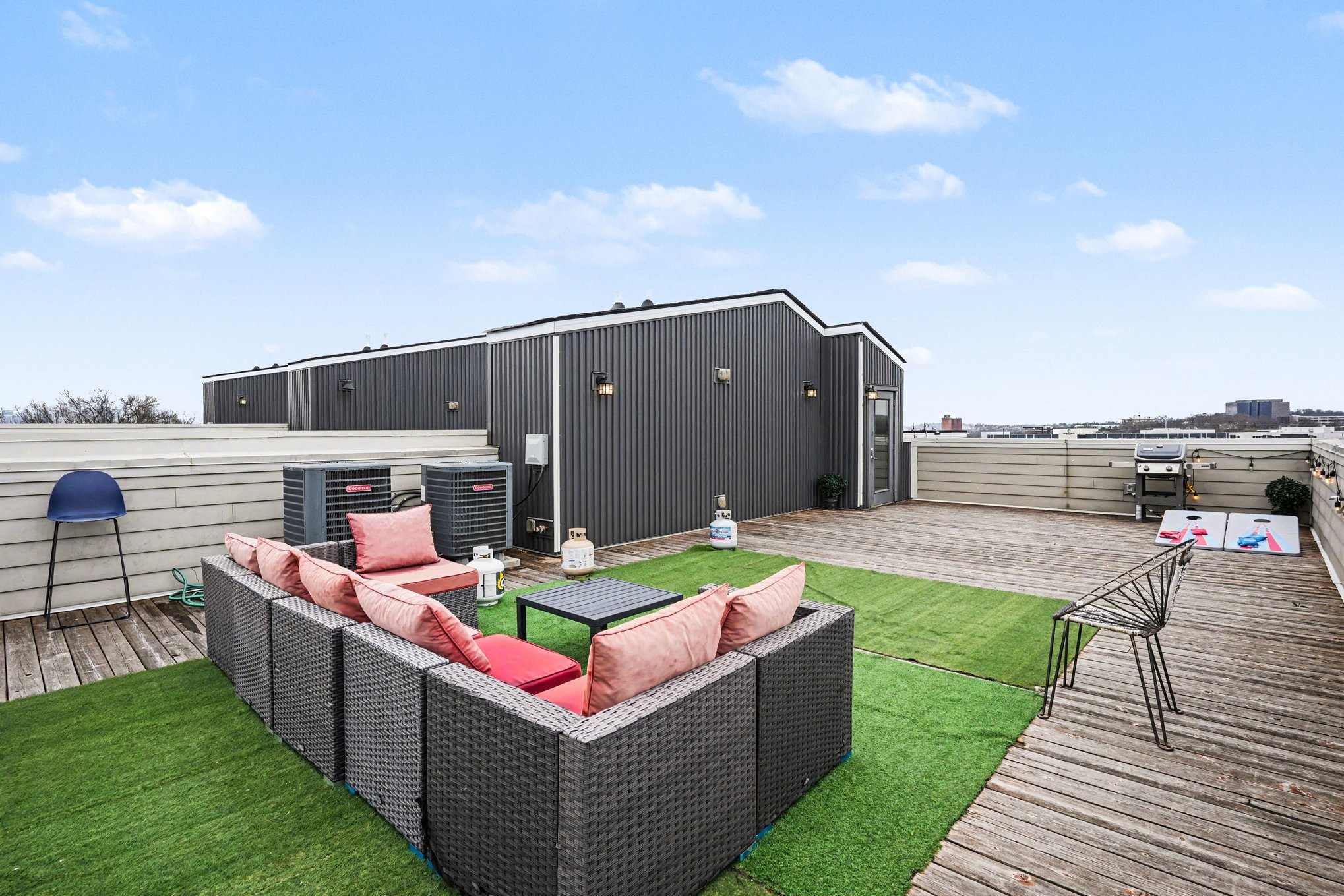 Rooftop patio with grill, corn hole, and views perfect for lounging | Unit A