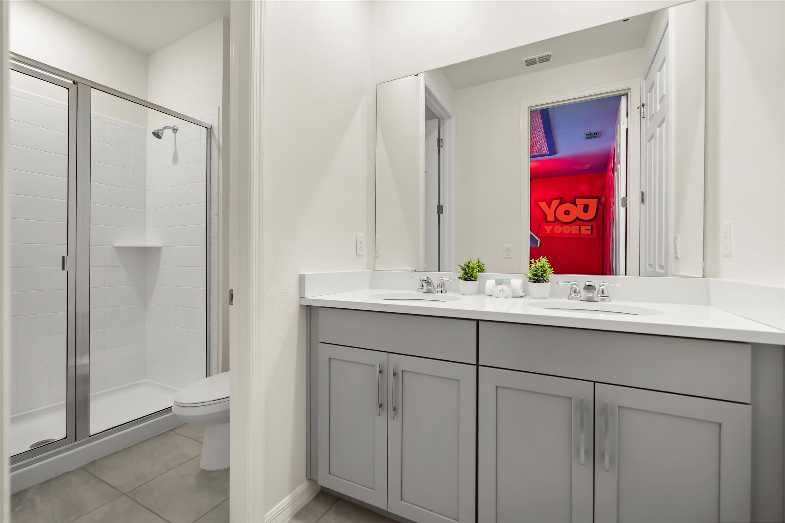 Full bathroom with double sinks and walk-in shower, perfect for kids and families in the Toy Story room.