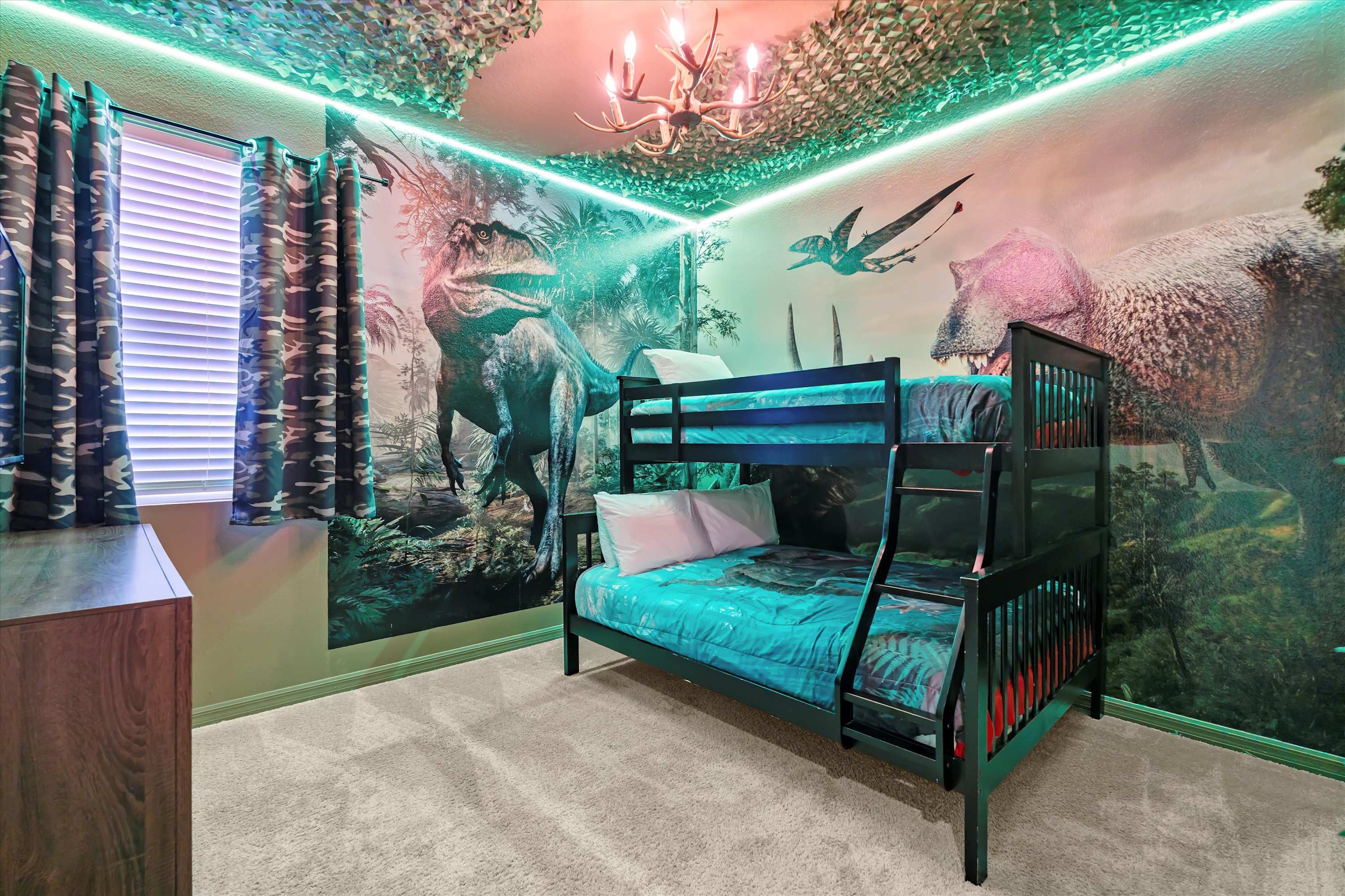Dinosaur themed bedroom with a bunk bed featuring a double on the bottom and single on top, perfect for kids and families