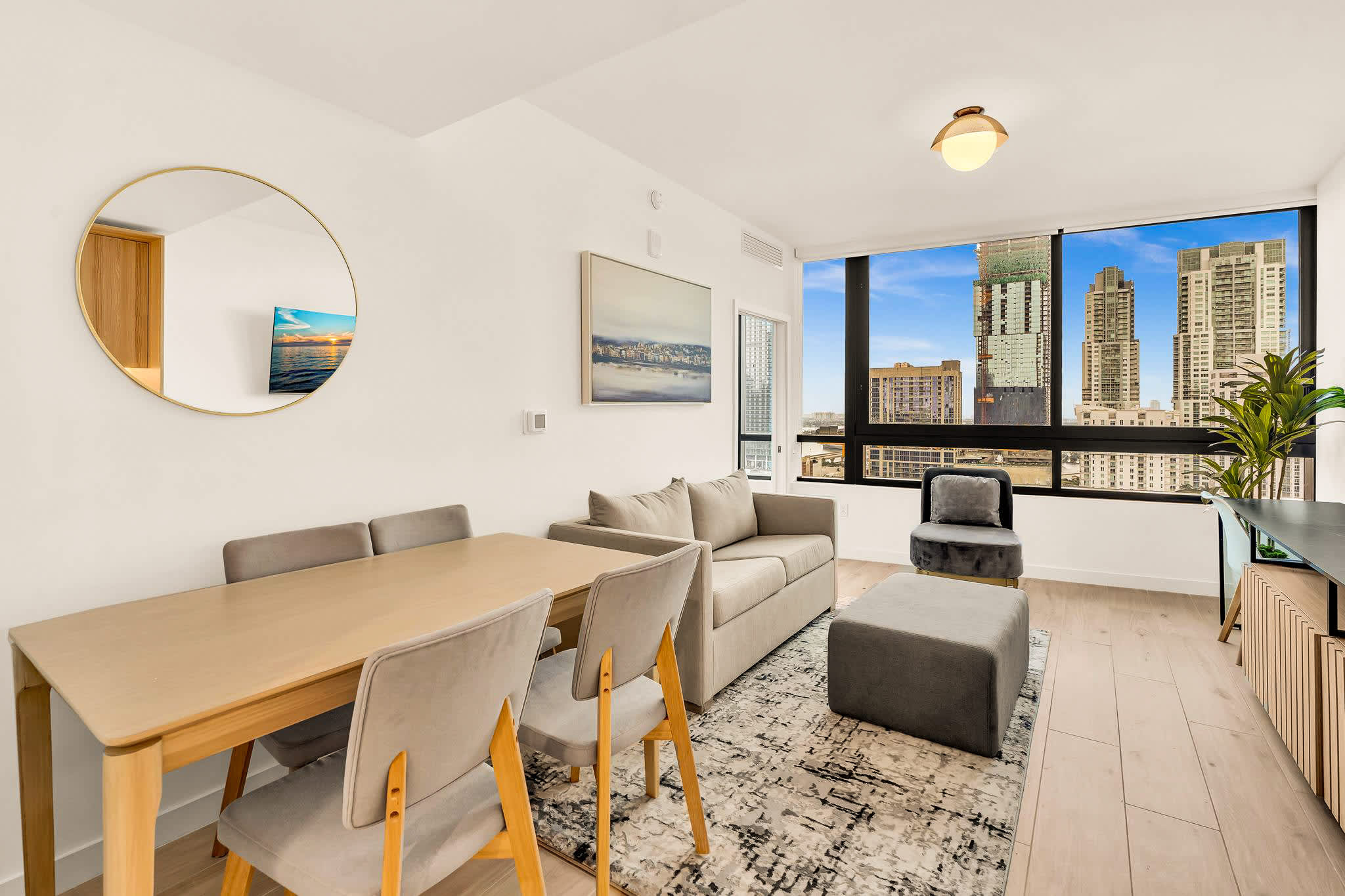 Enjoy stunning city views from this modern living space, perfect for relaxation and dining.
