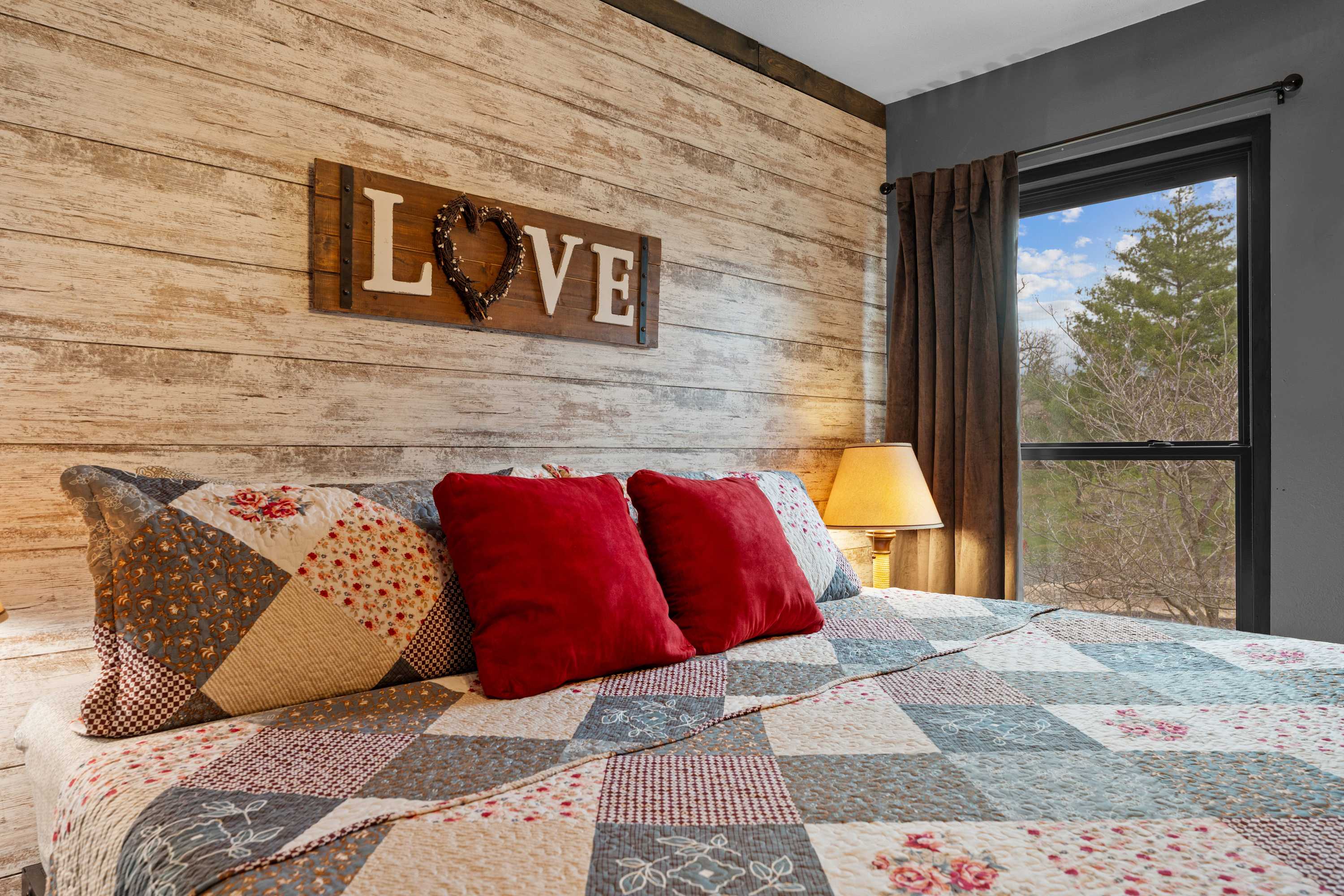 The bedroom retreat boasts a plush king bed, smart TV, & an ensuite bath​