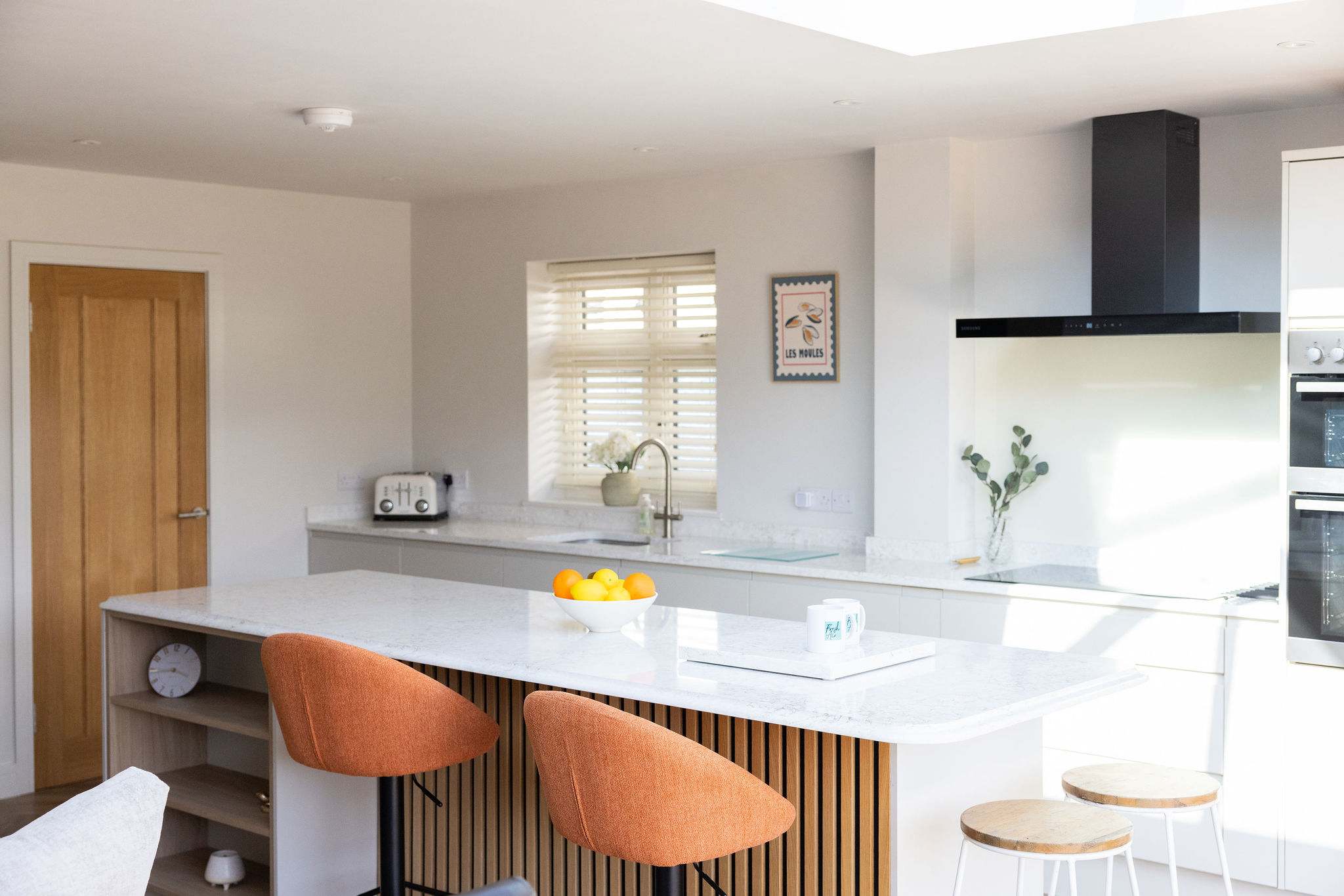 Modern kitchen with island seating, perfect for relaxed cooking and dining.