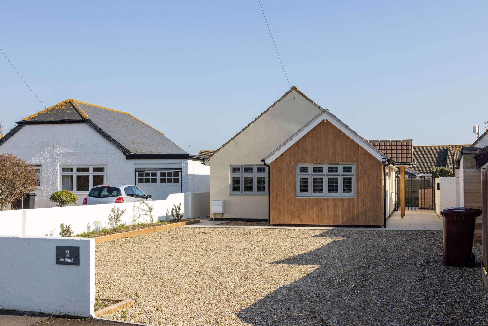 Stylish seaside home with private driveway parking and a welcoming, modern exterior.