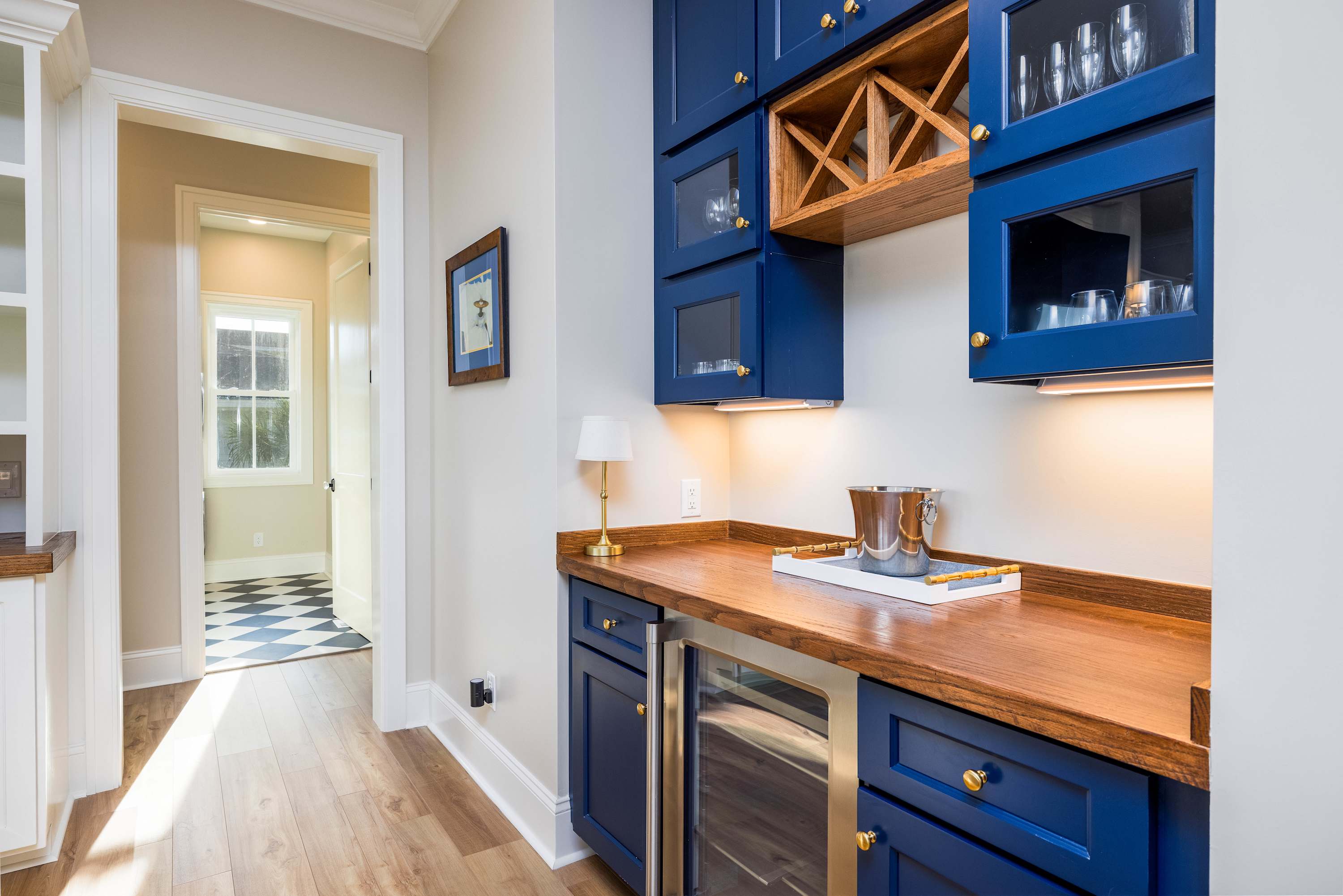 Bar with Wine Cooler and Hallway to Laundry/Primary Bedrooms