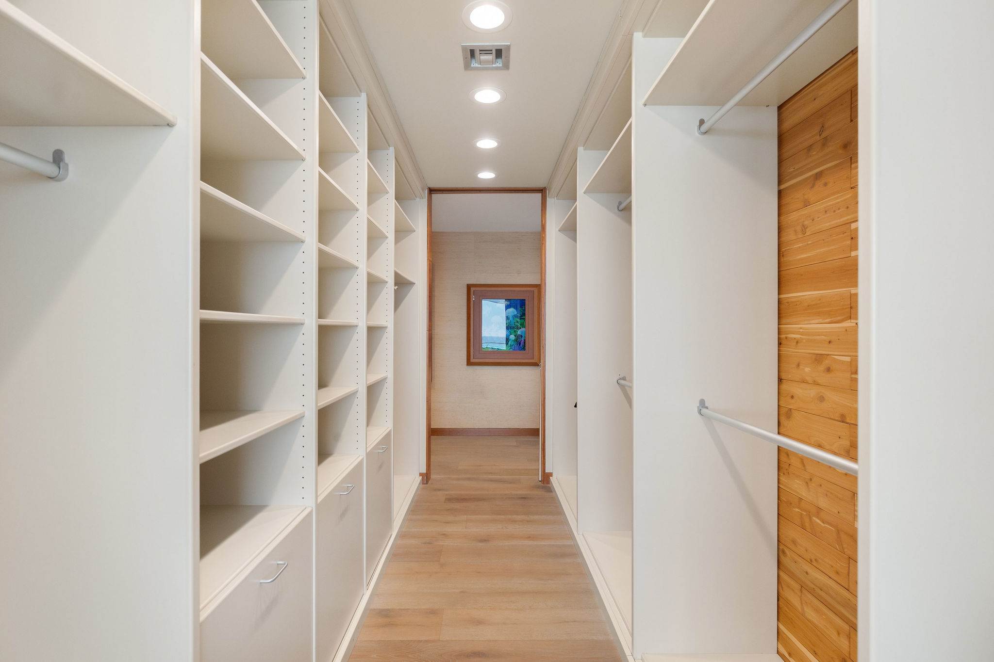 Custom walk-in closet with built-in shelving in a Malibu luxury residence.