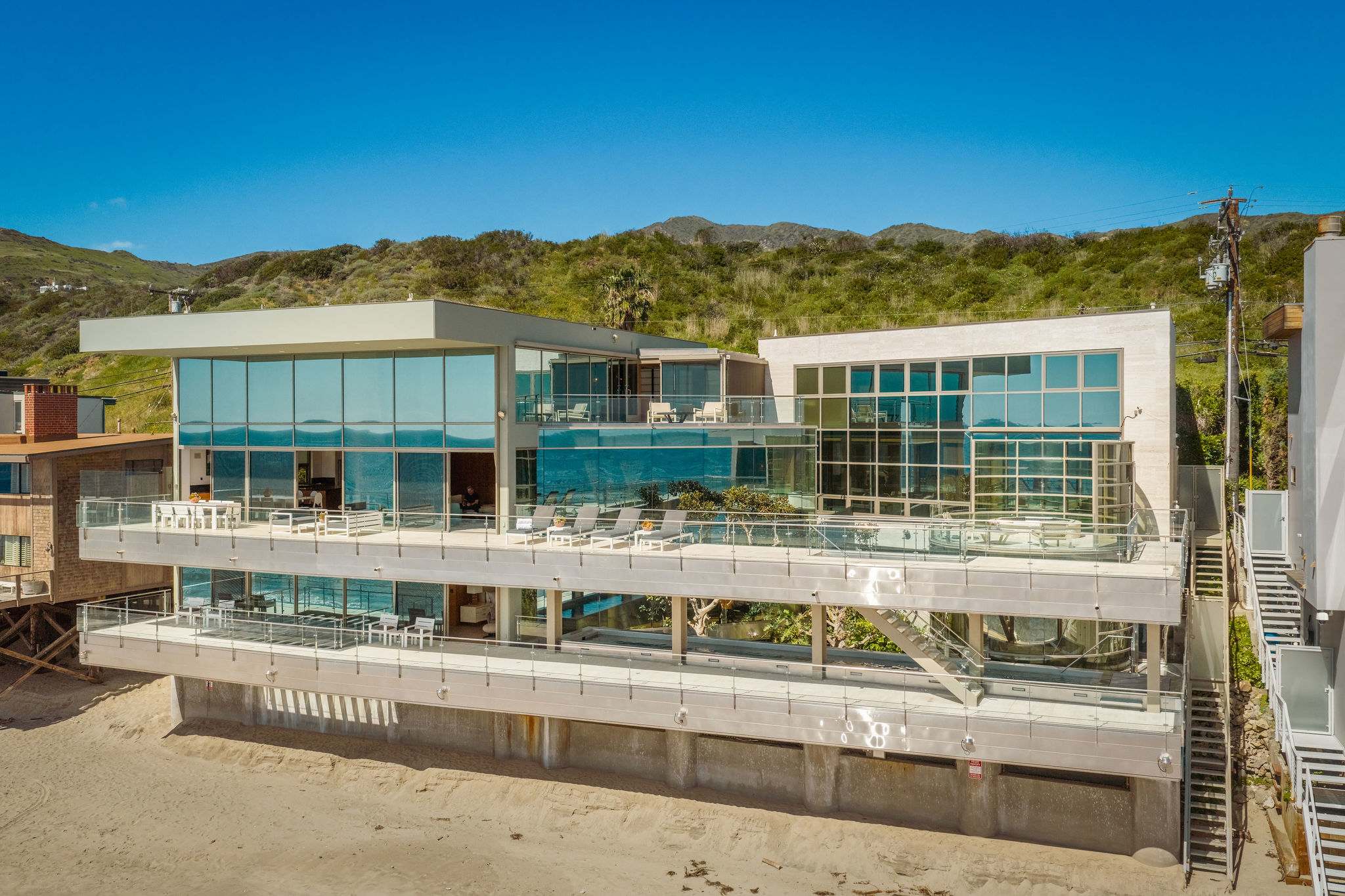 Malibu beachfront residence viewed directly from the Pacific shoreline.