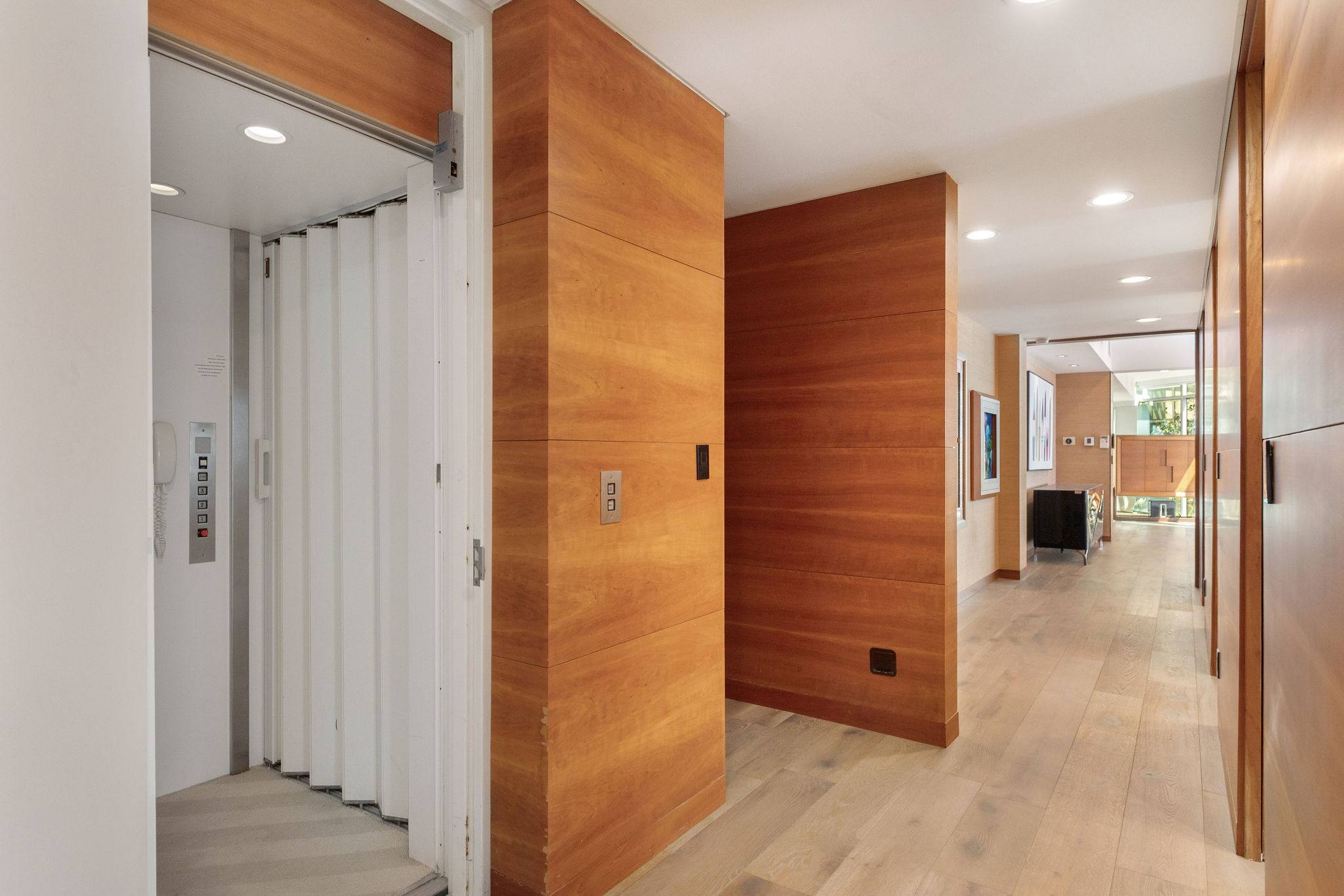 Walk-in wardrobe corridor with built-in storage.