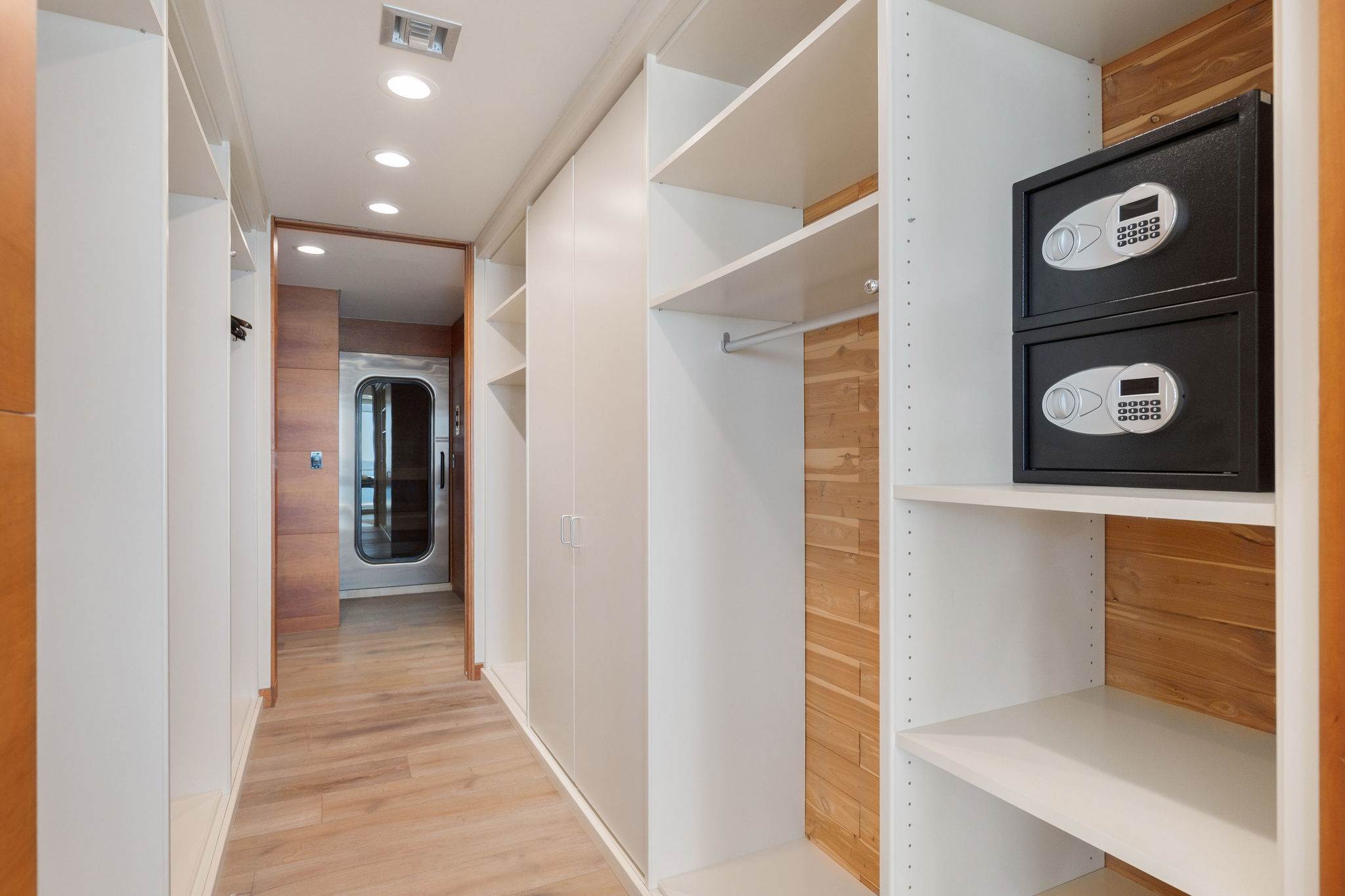Dressing gallery with tailored cabinetry and wardrobe storage.