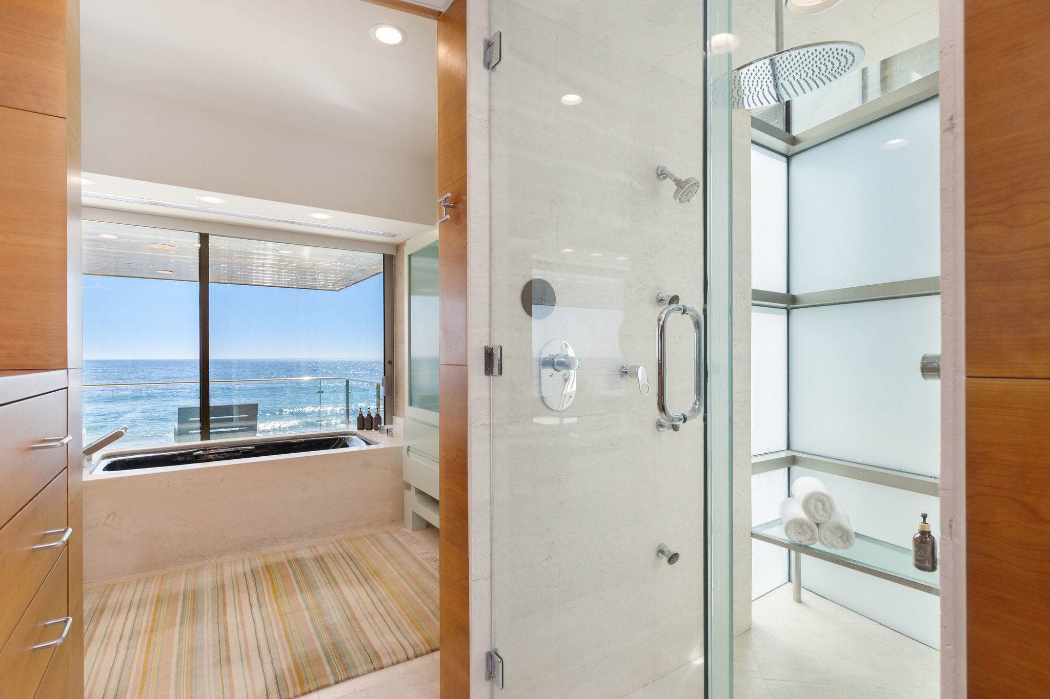 Glass walk-in shower within a luxury Malibu oceanfront bathroom.