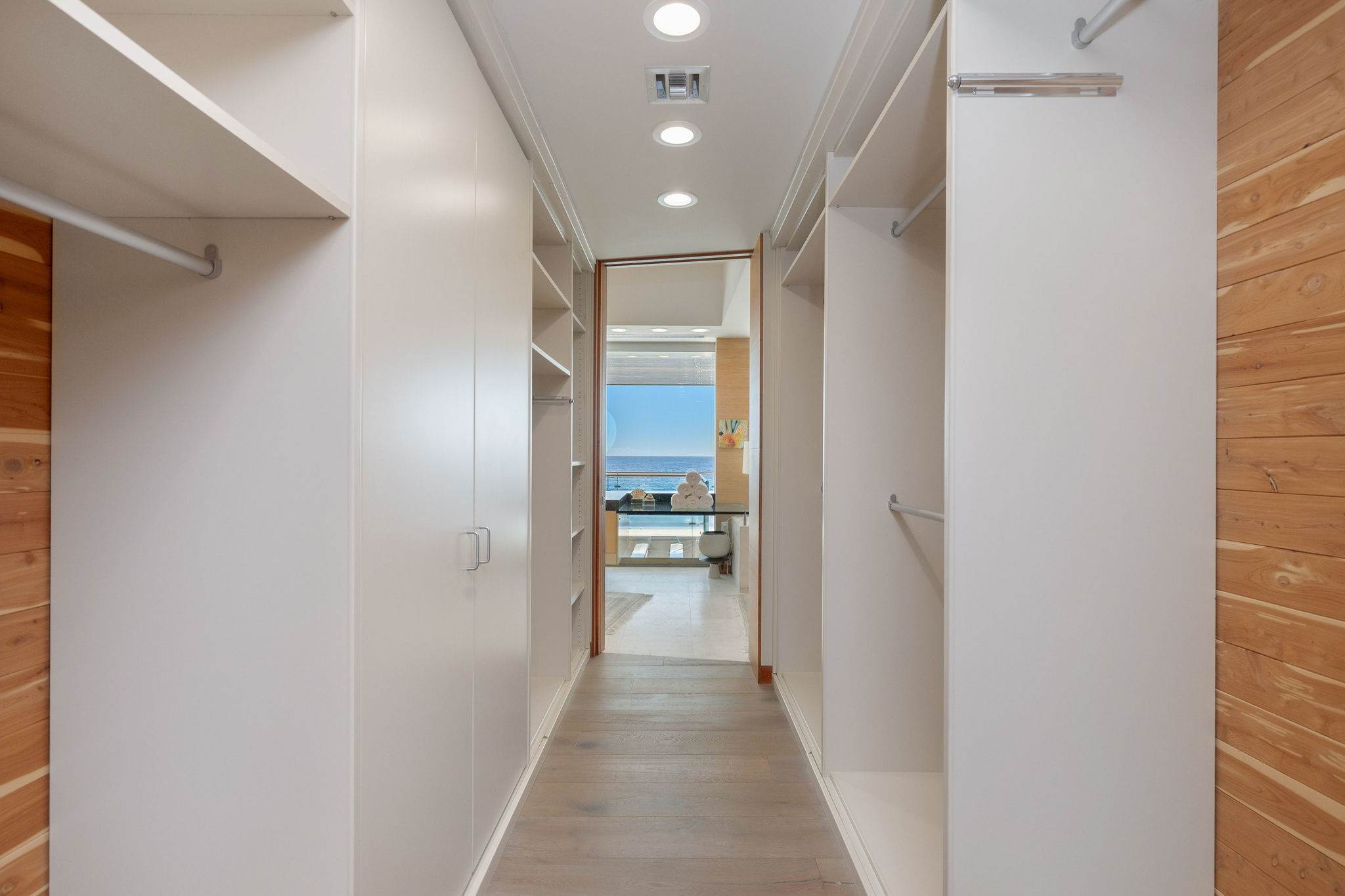 Custom walk-in dressing corridor with built-in wardrobes in this Malibu oceanfront residence.