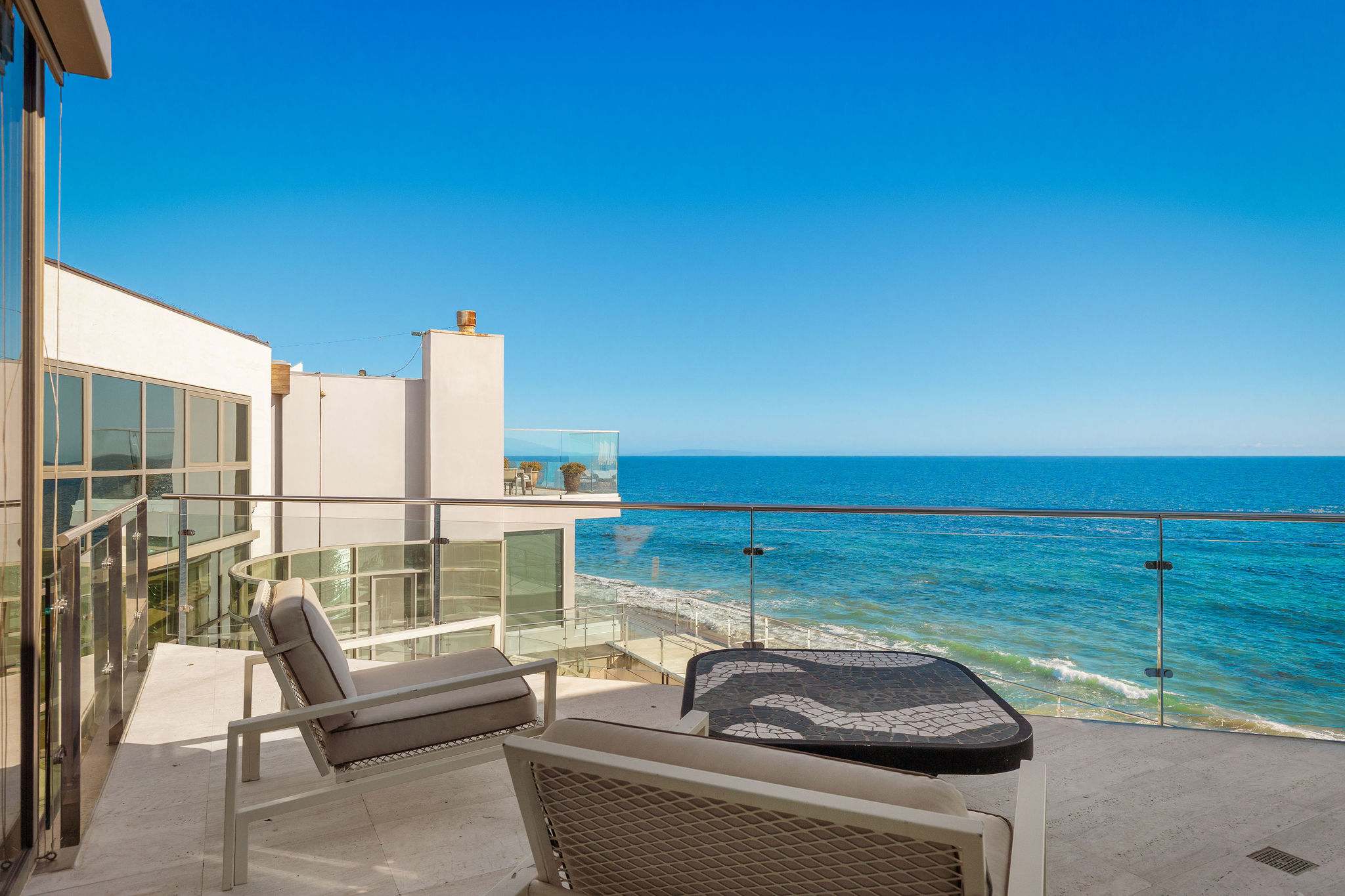 Oceanfront terrace lounge overlooking Malibu’s coastline.