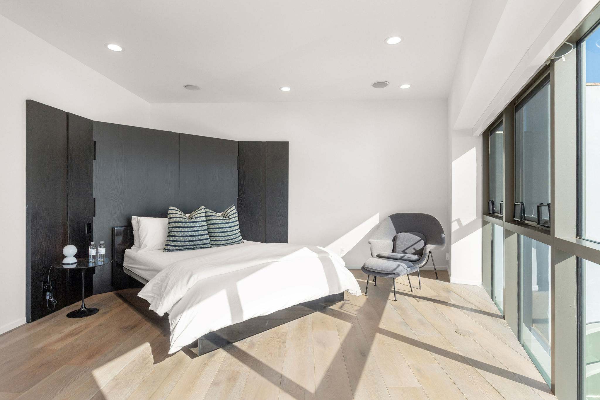 Oceanview bedroom with floor-to-ceiling glass in a Malibu beachfront estate.