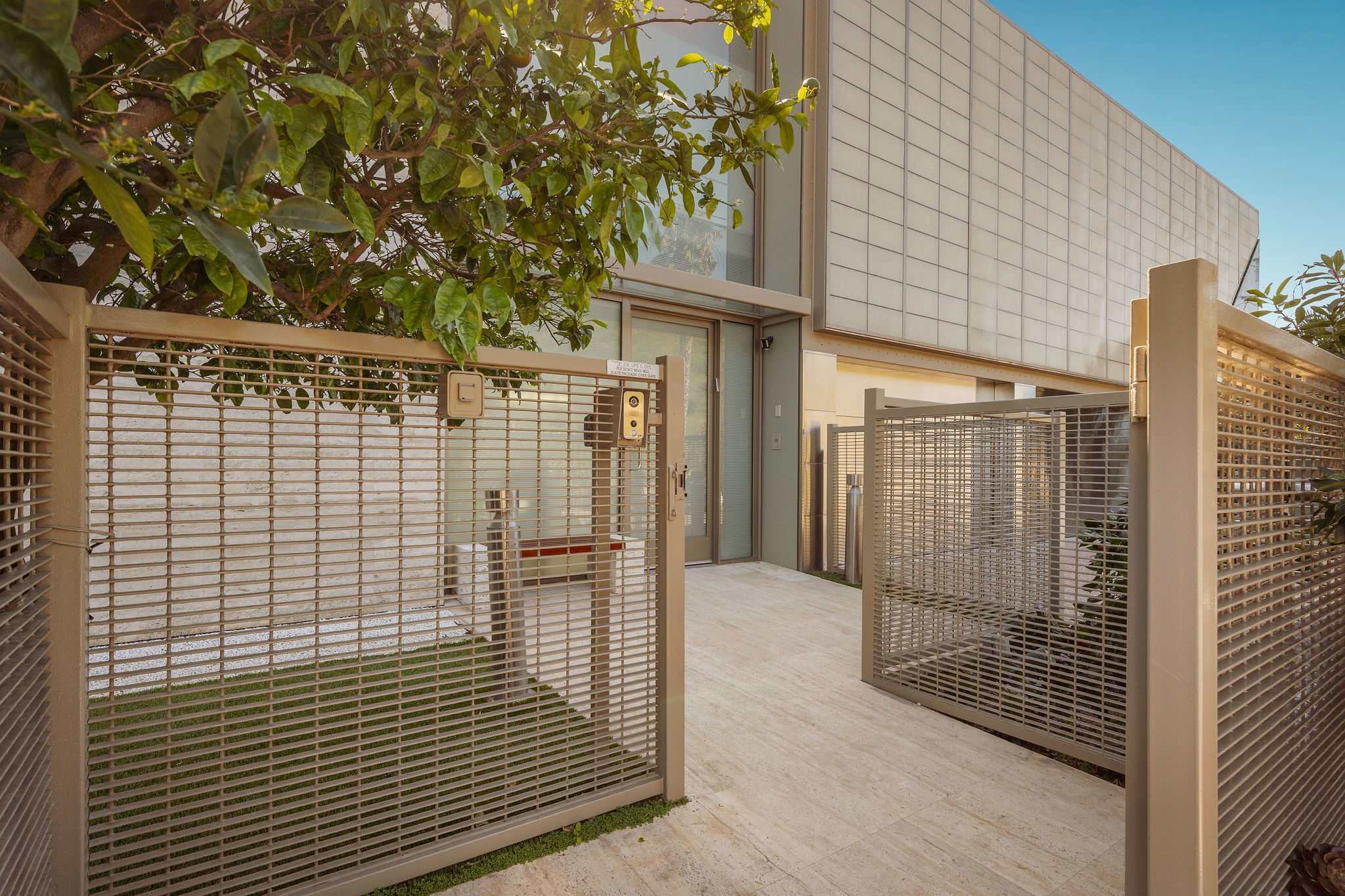 Private gated entry walkway leading into this Malibu luxury residence.