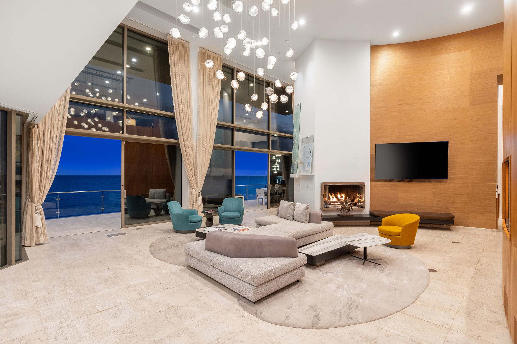 Grand Malibu oceanfront living room with double-height ceilings and floor-to-ceiling glass.