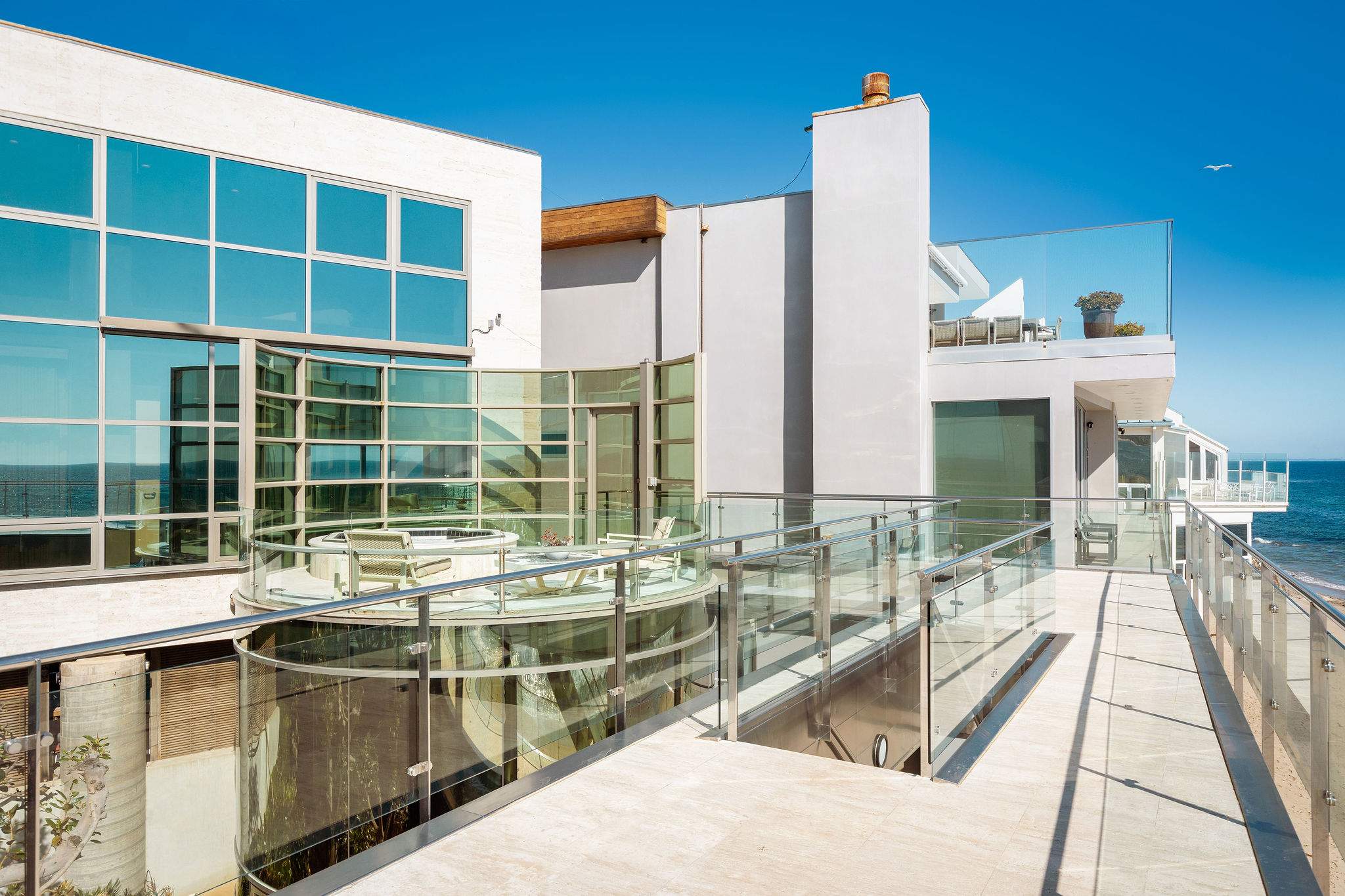 Oceanfront Malibu deck positioned above the shoreline.