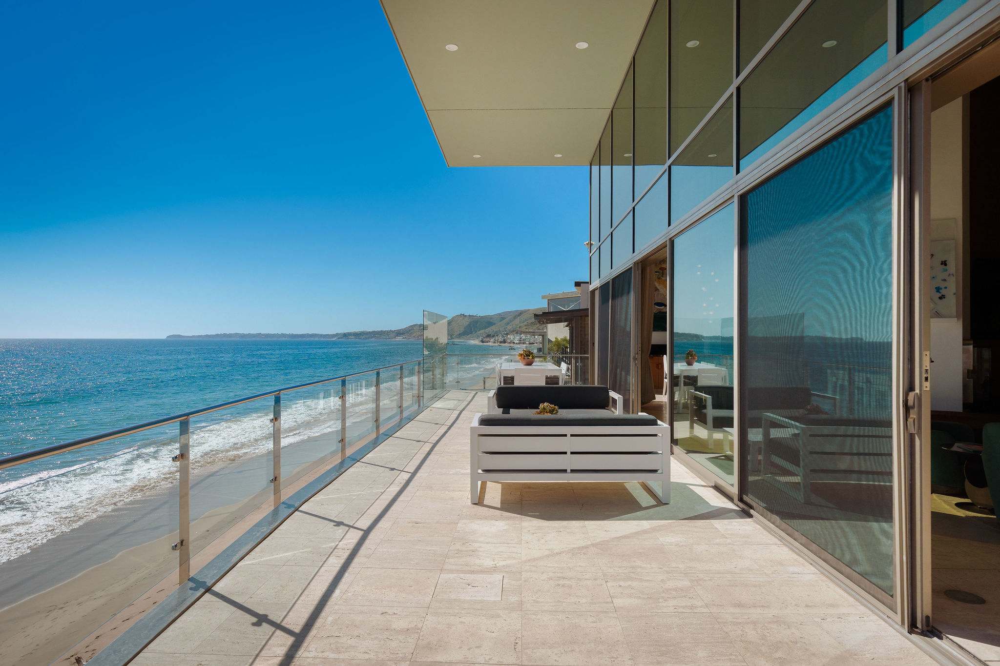 Oceanfront Malibu terrace set directly above the Pacific shoreline.