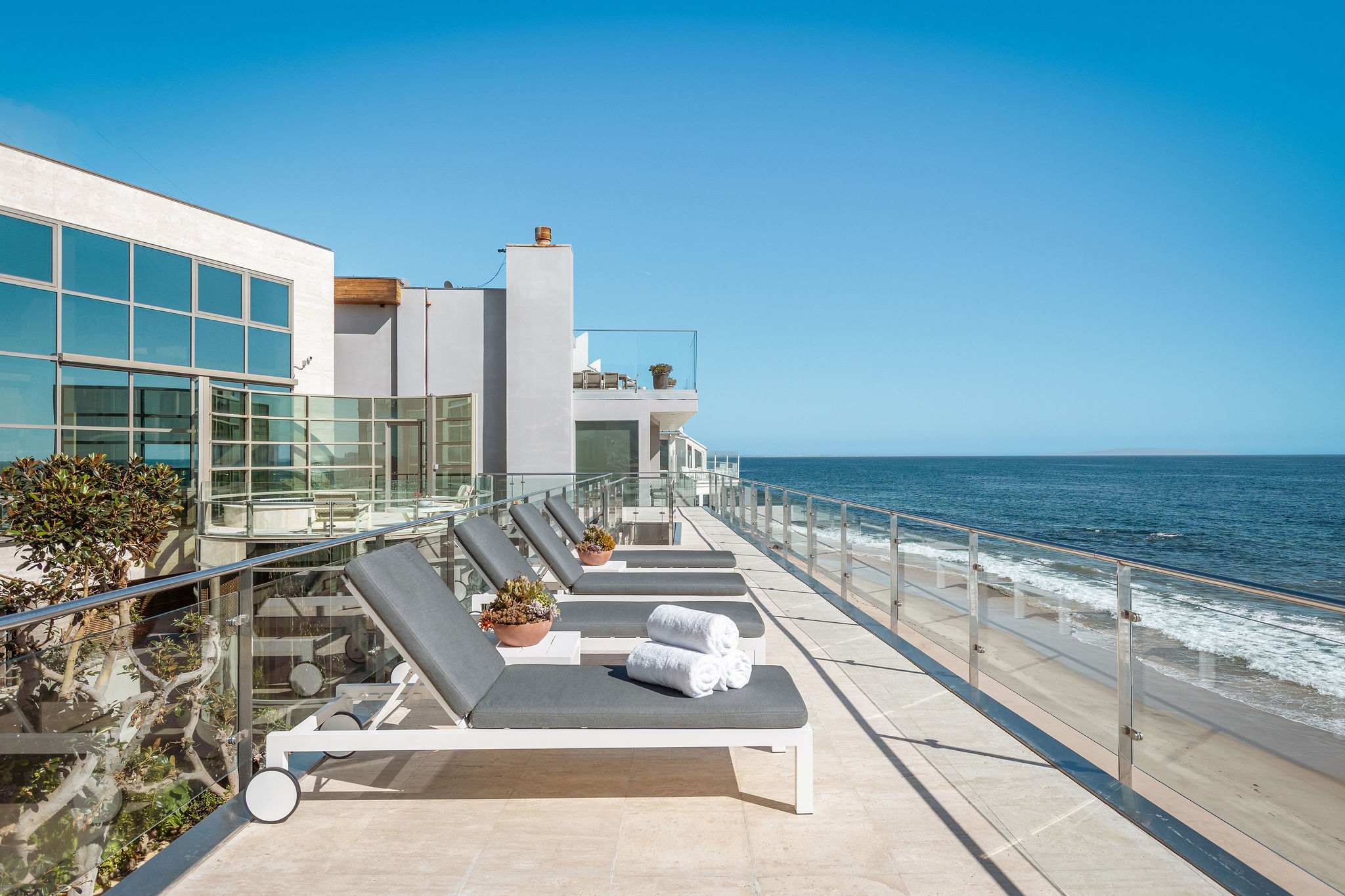 Beachfront sun deck set directly above Malibu’s Pacific coastline.