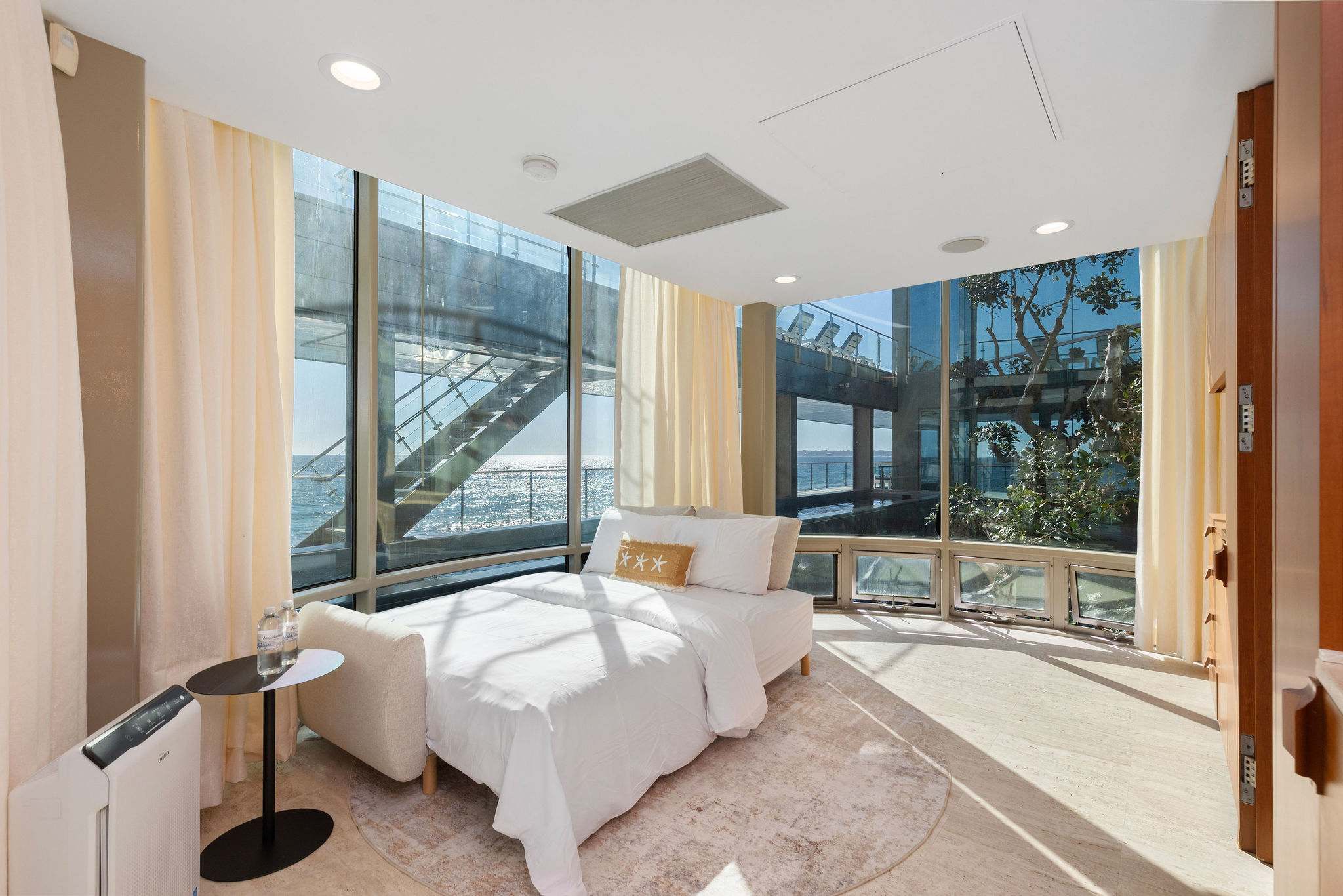 Guest bedroom with floor-to-ceiling windows in a Malibu estate.