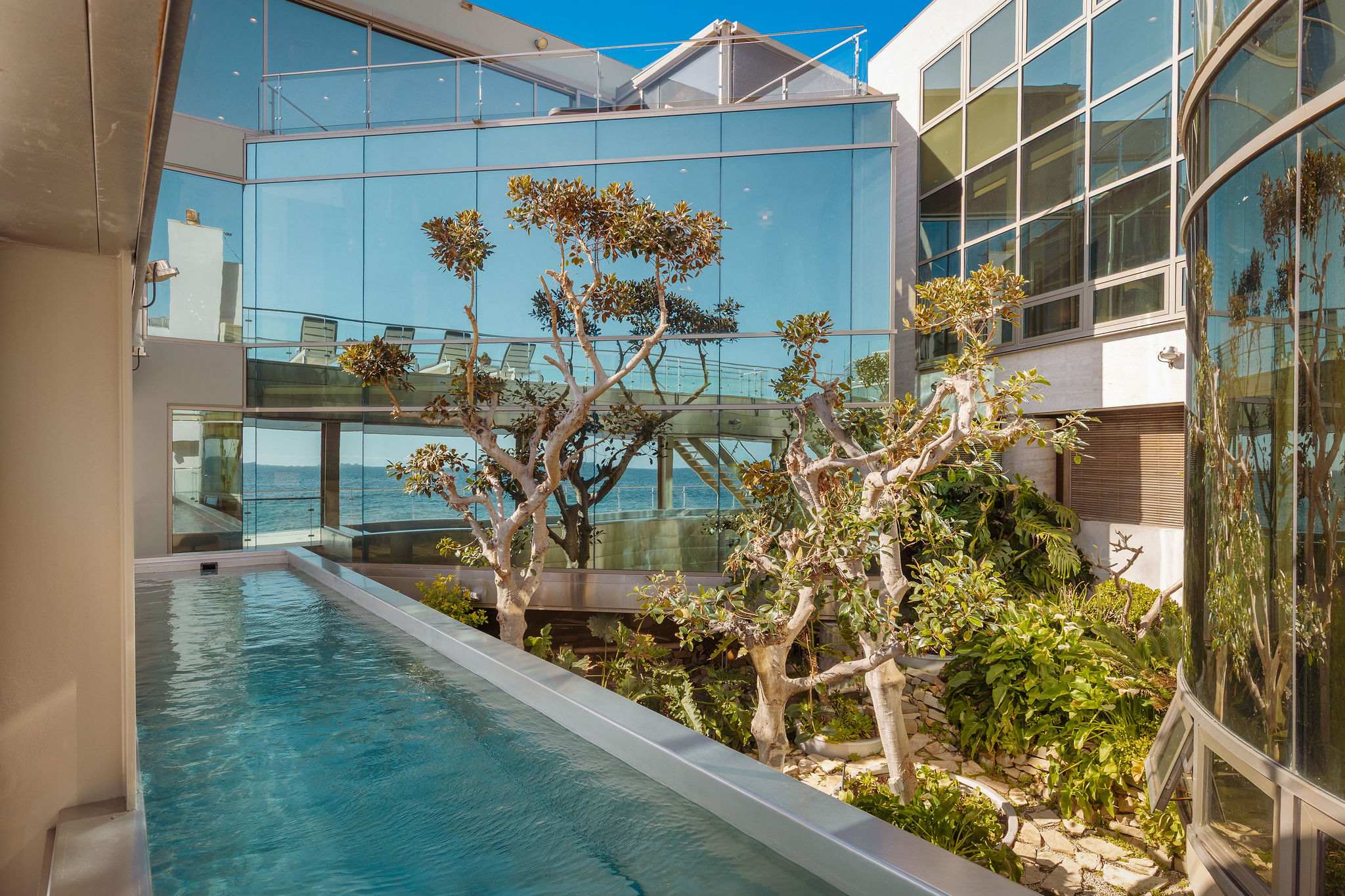 Private water courtyard framed by contemporary Malibu architecture.