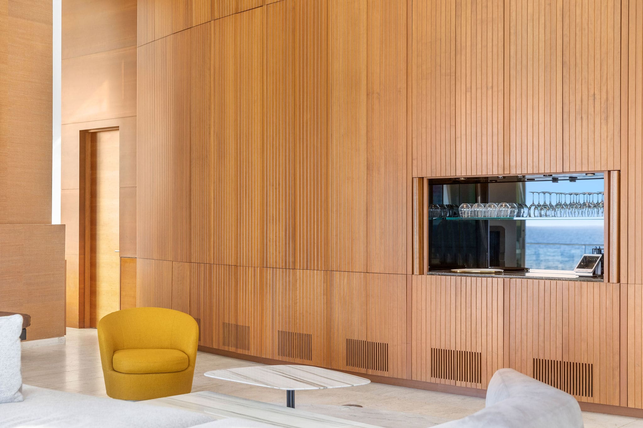 Architectural interior with dramatic wood-paneled walls and modern Malibu design.
