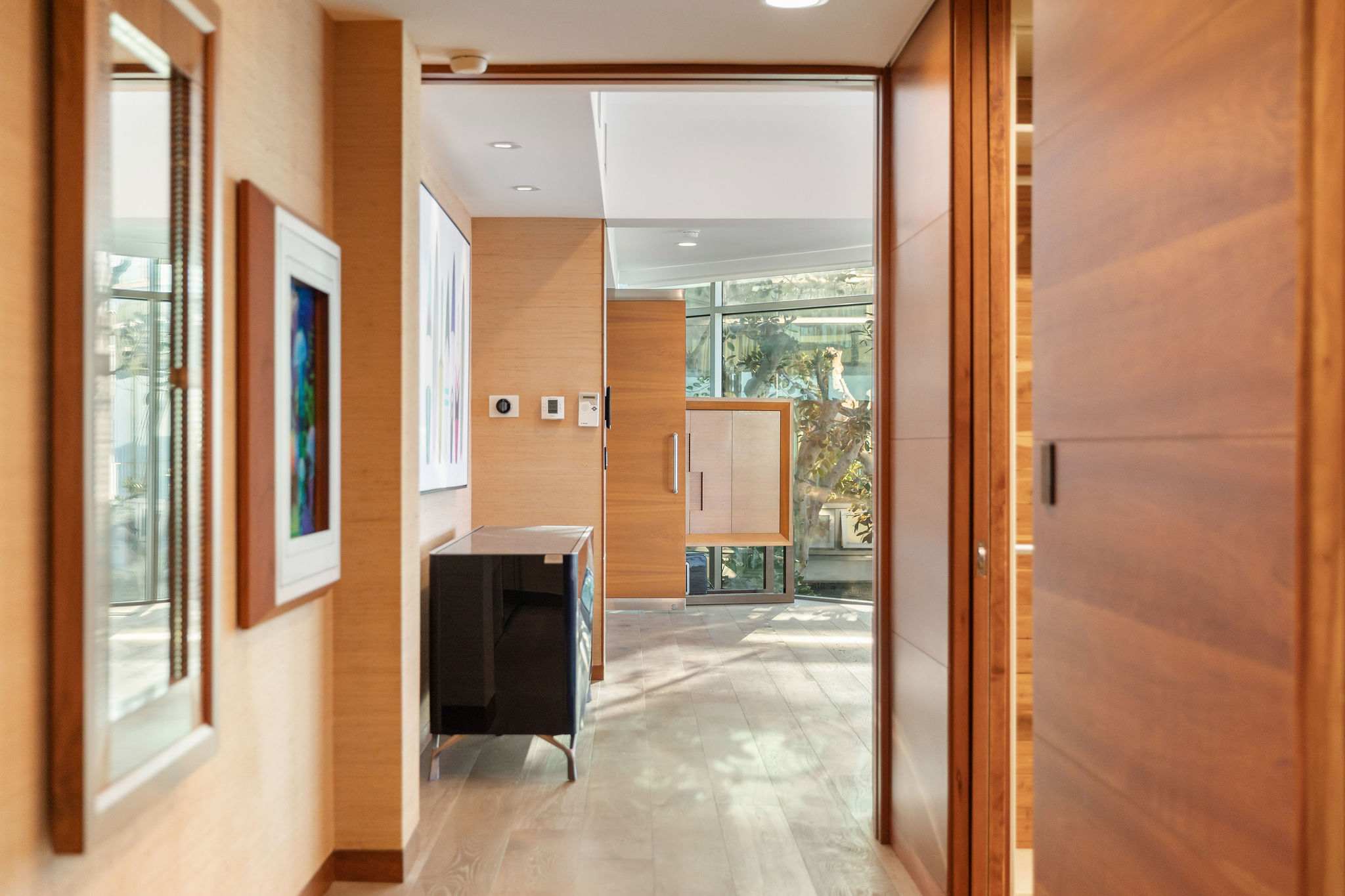 Contemporary hallway with custom wood paneling in a Malibu luxury residence.