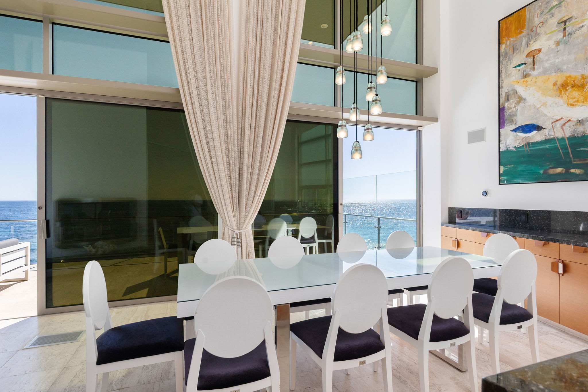 Oceanfront dining table with panoramic Malibu views.