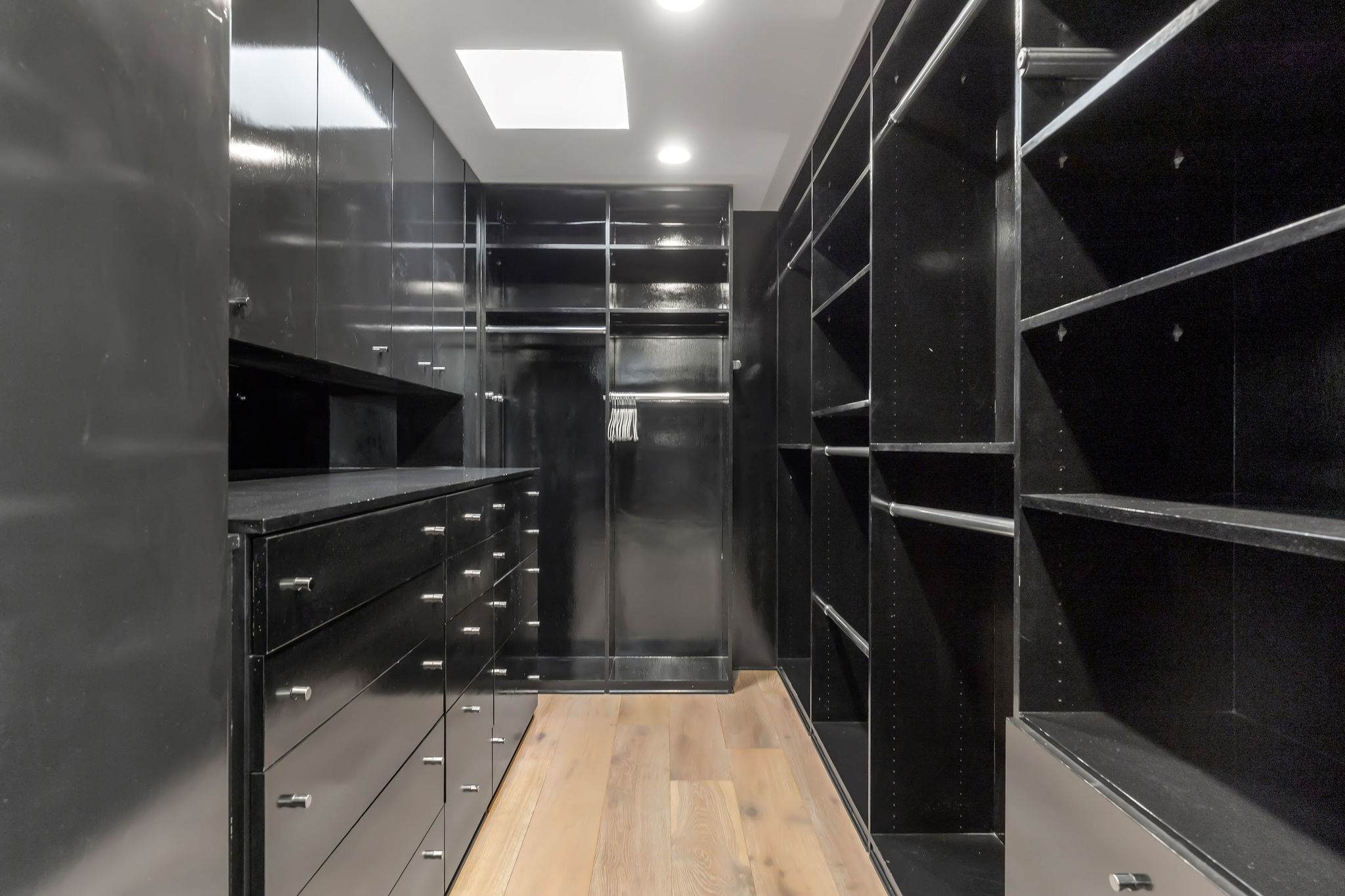 Custom walk-in closet with built-in shelving in a Malibu luxury residence.