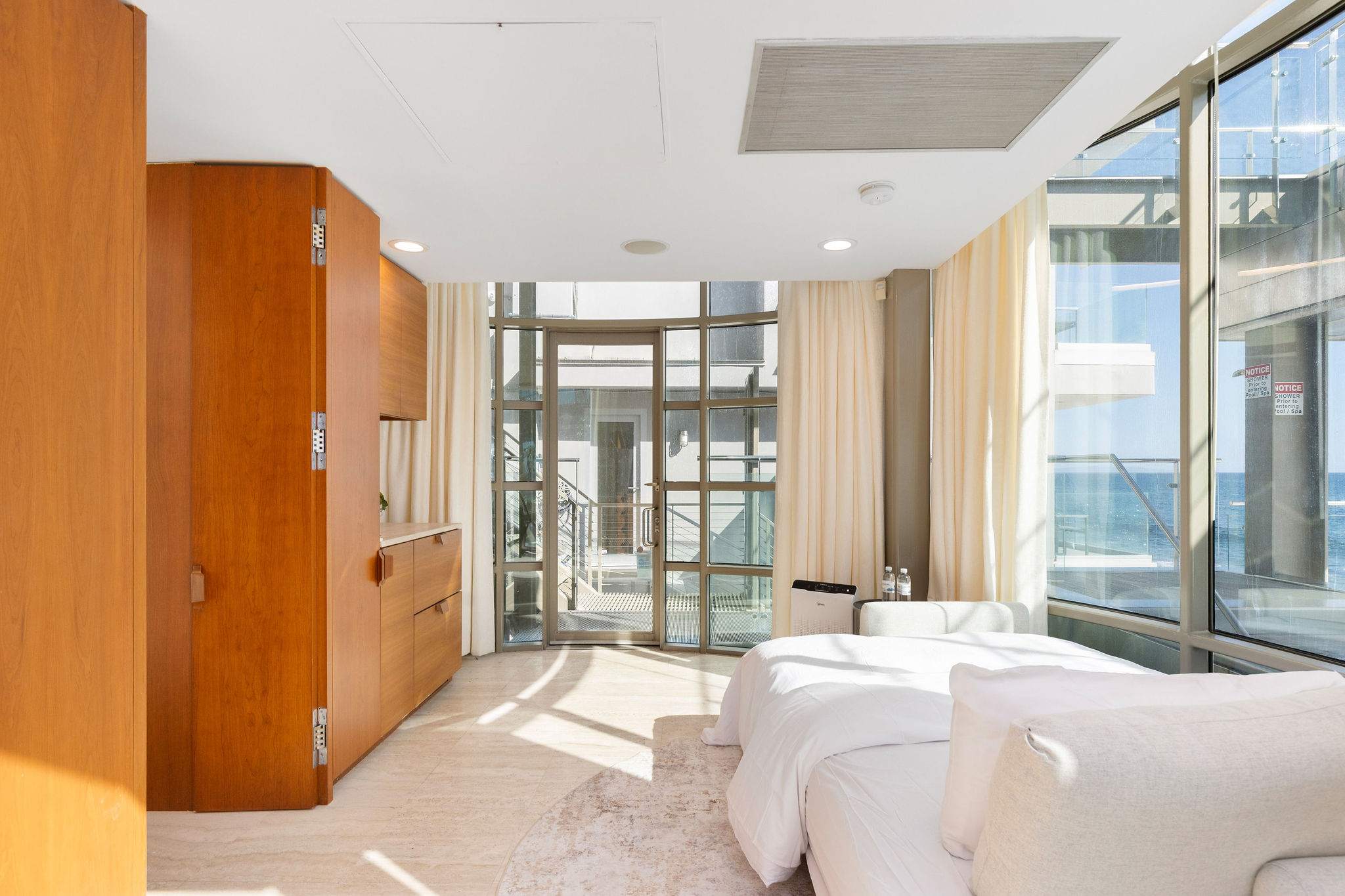 Oceanview bedroom suite with floor-to-ceiling windows in this Malibu beachfront residence.