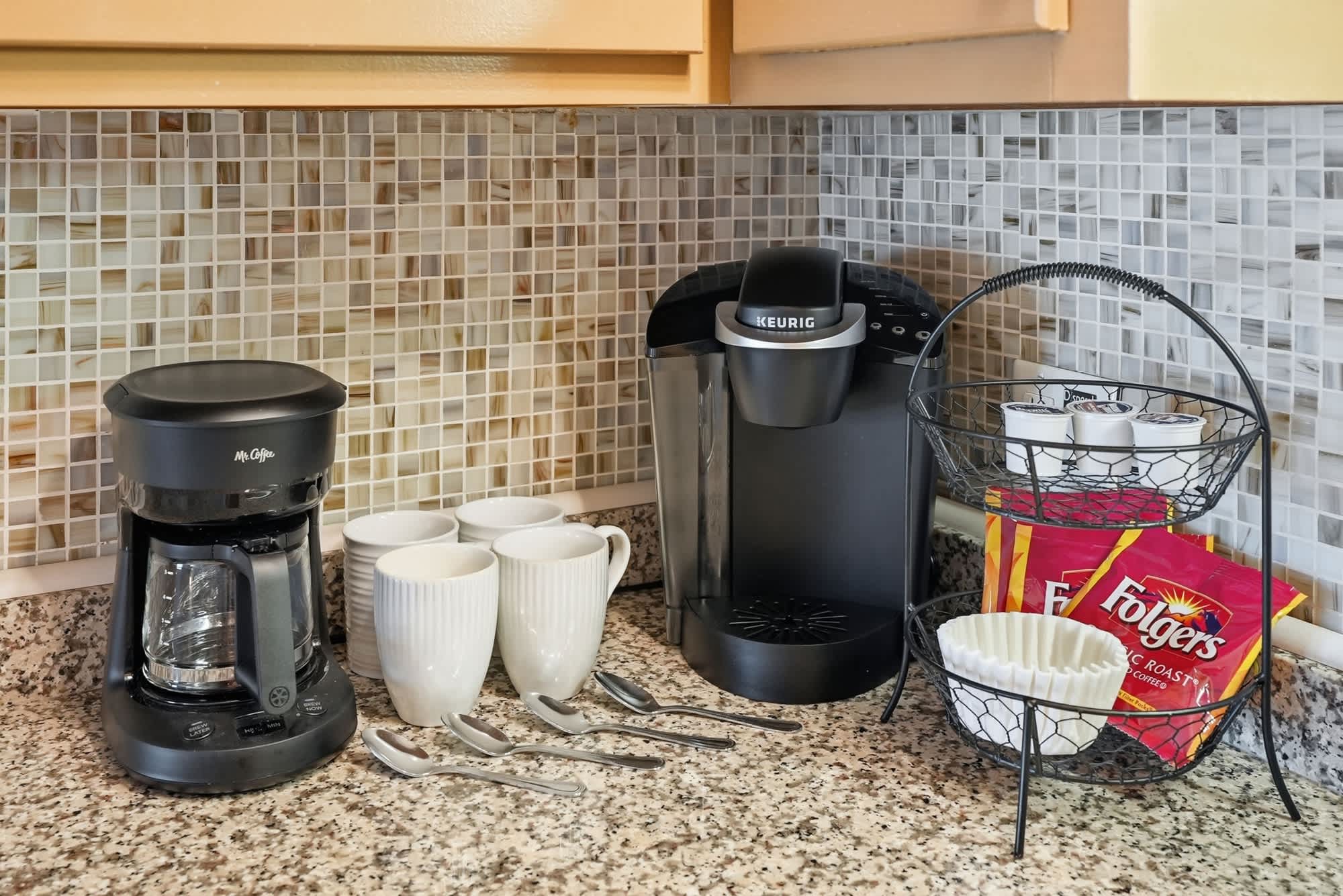 The Summit 419 – Coffee station with Mr. Coffee, Keurig, cups, spoons, and coffee supplies on a granite countertop.