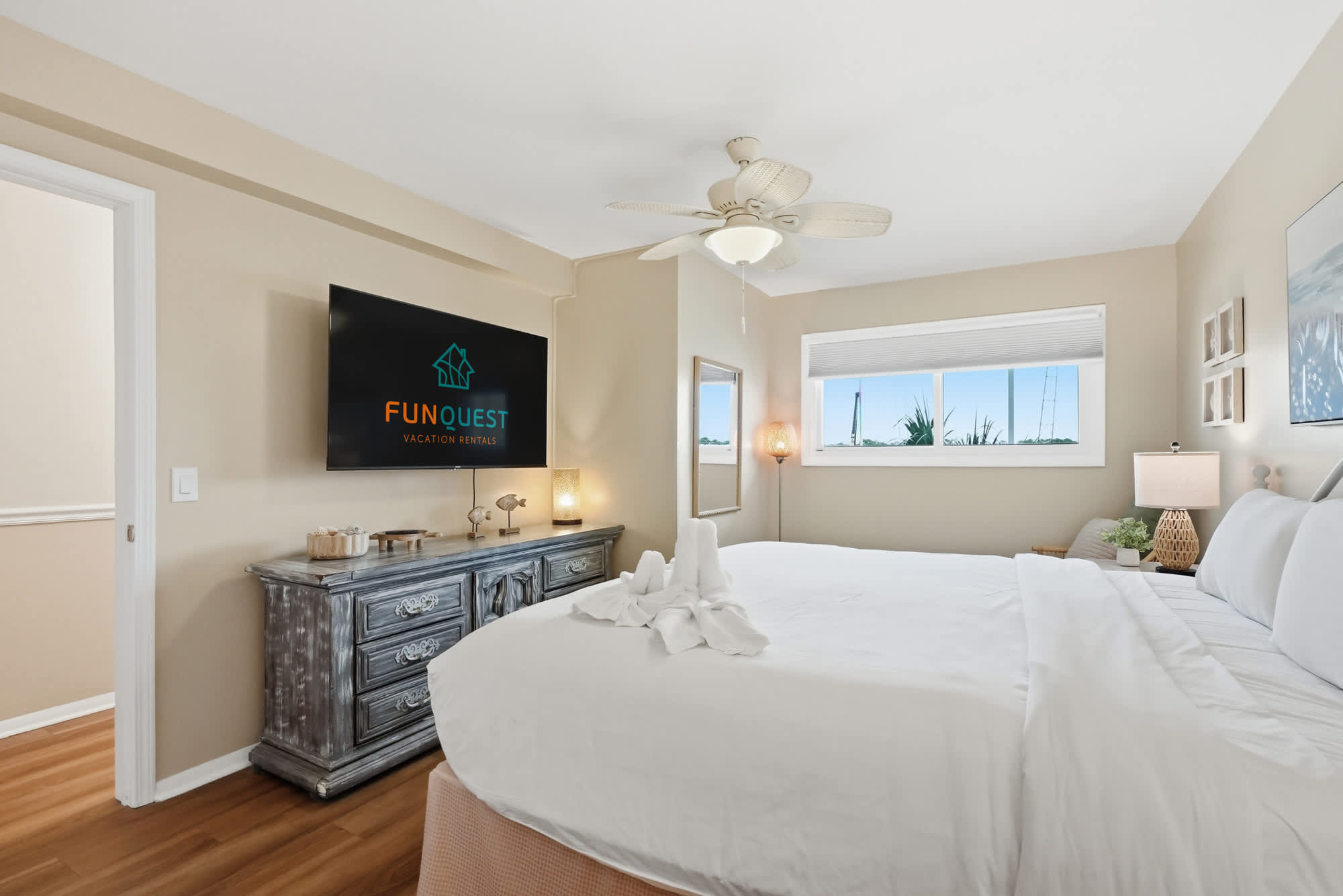 The Summit 419 – Bright bedroom with a large bed, dresser, TV, and window view.