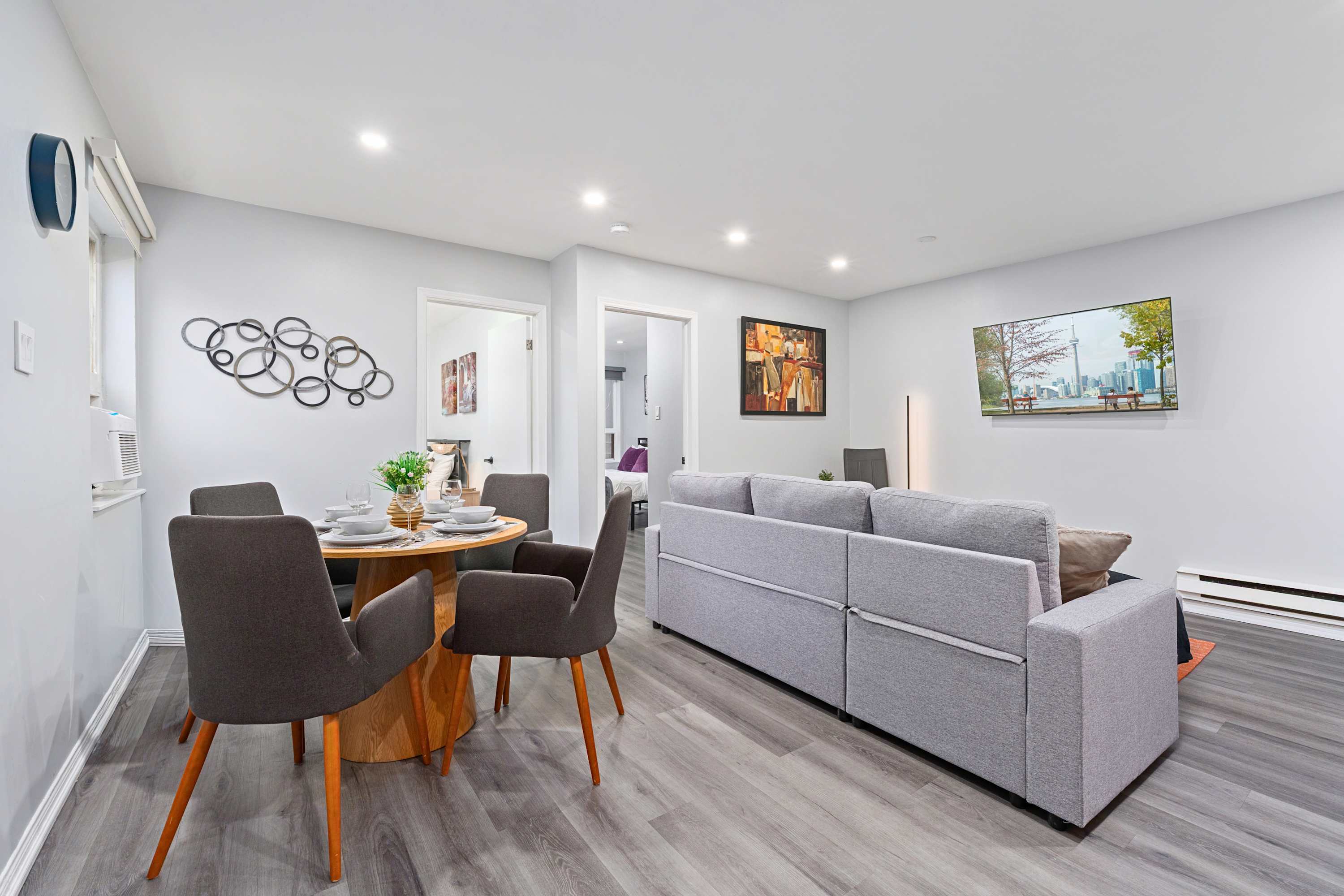 Dining table with living area and TV offers a complete space for meals and leisure.