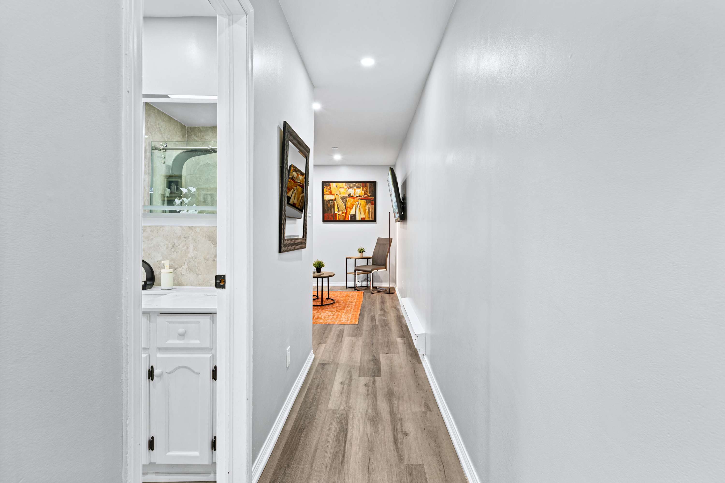 Open living leading to a modern bathroom. Everything you need to refresh.