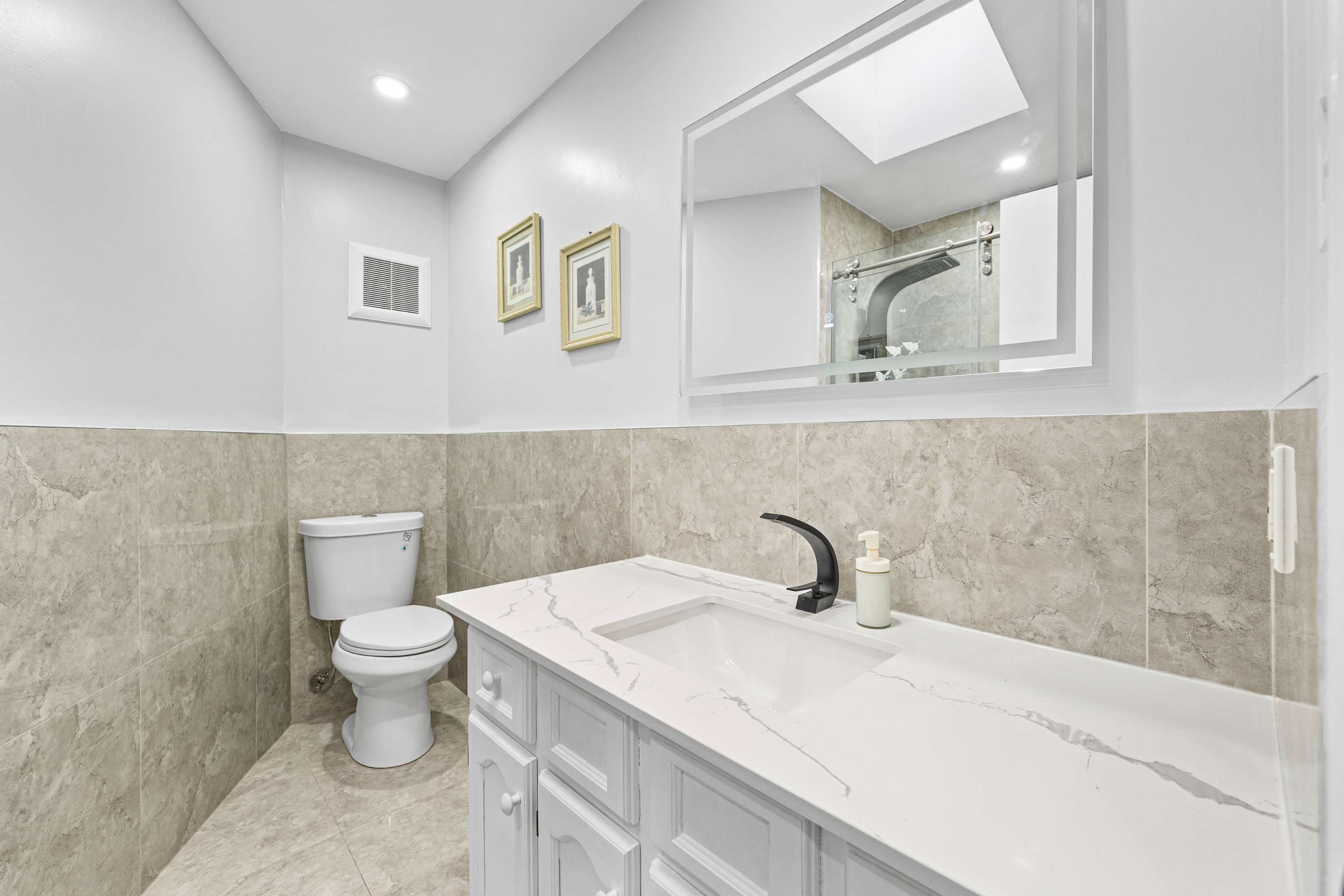 A clean vanity room and bathroom area.