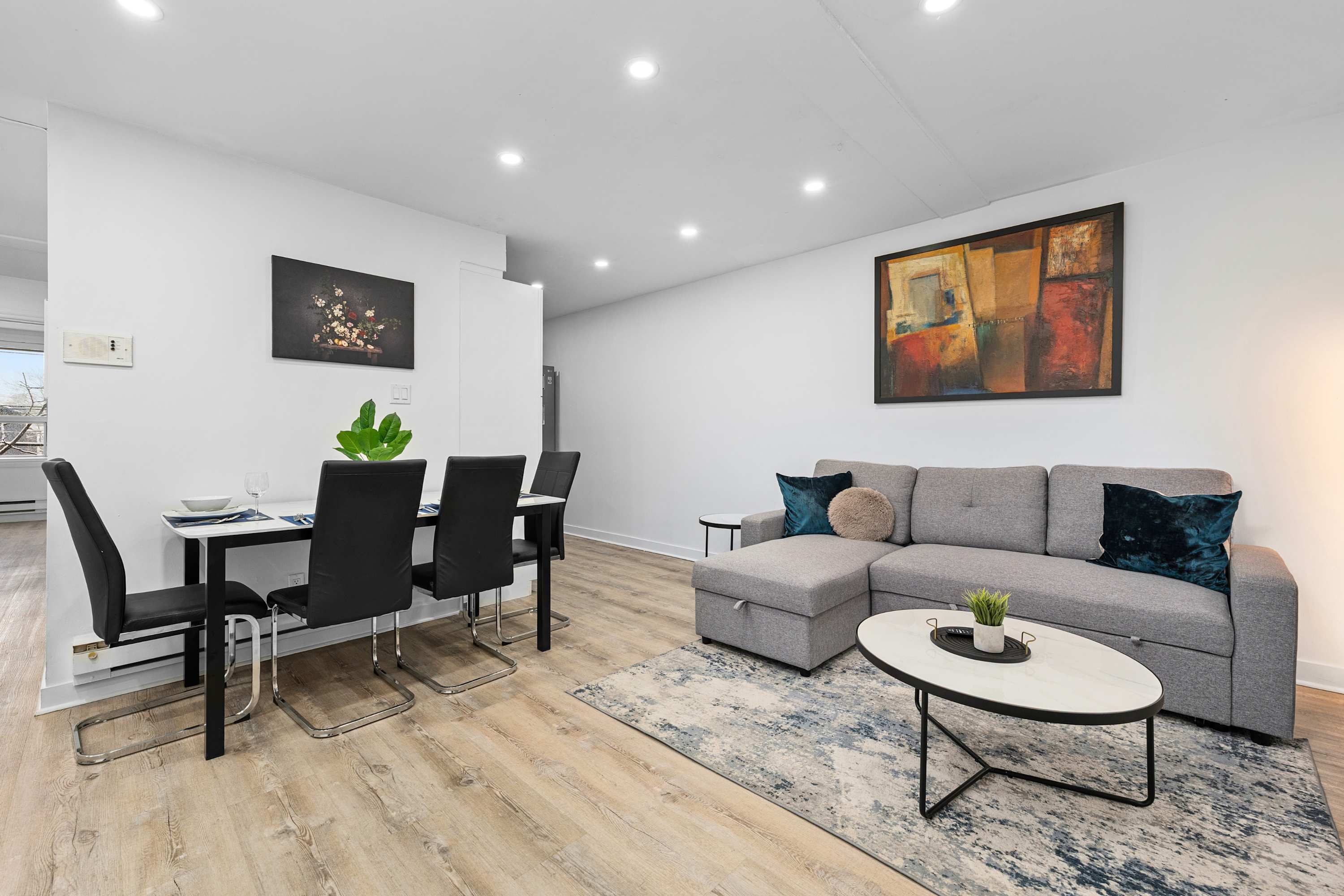 Living and dining area with cozy seating and a stylish table