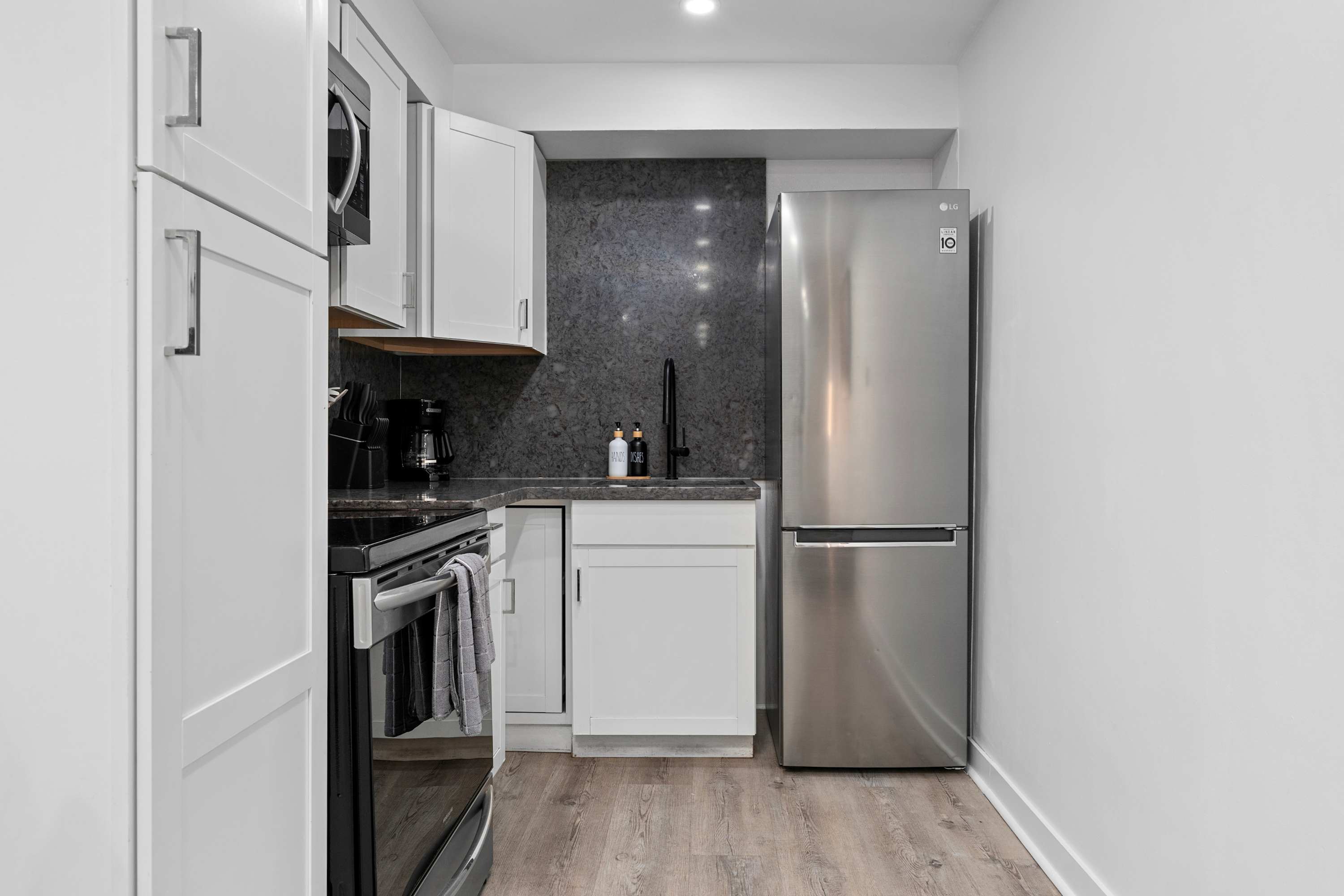 Open kitchen with appliances, perfect for preparing home-cooked meals.