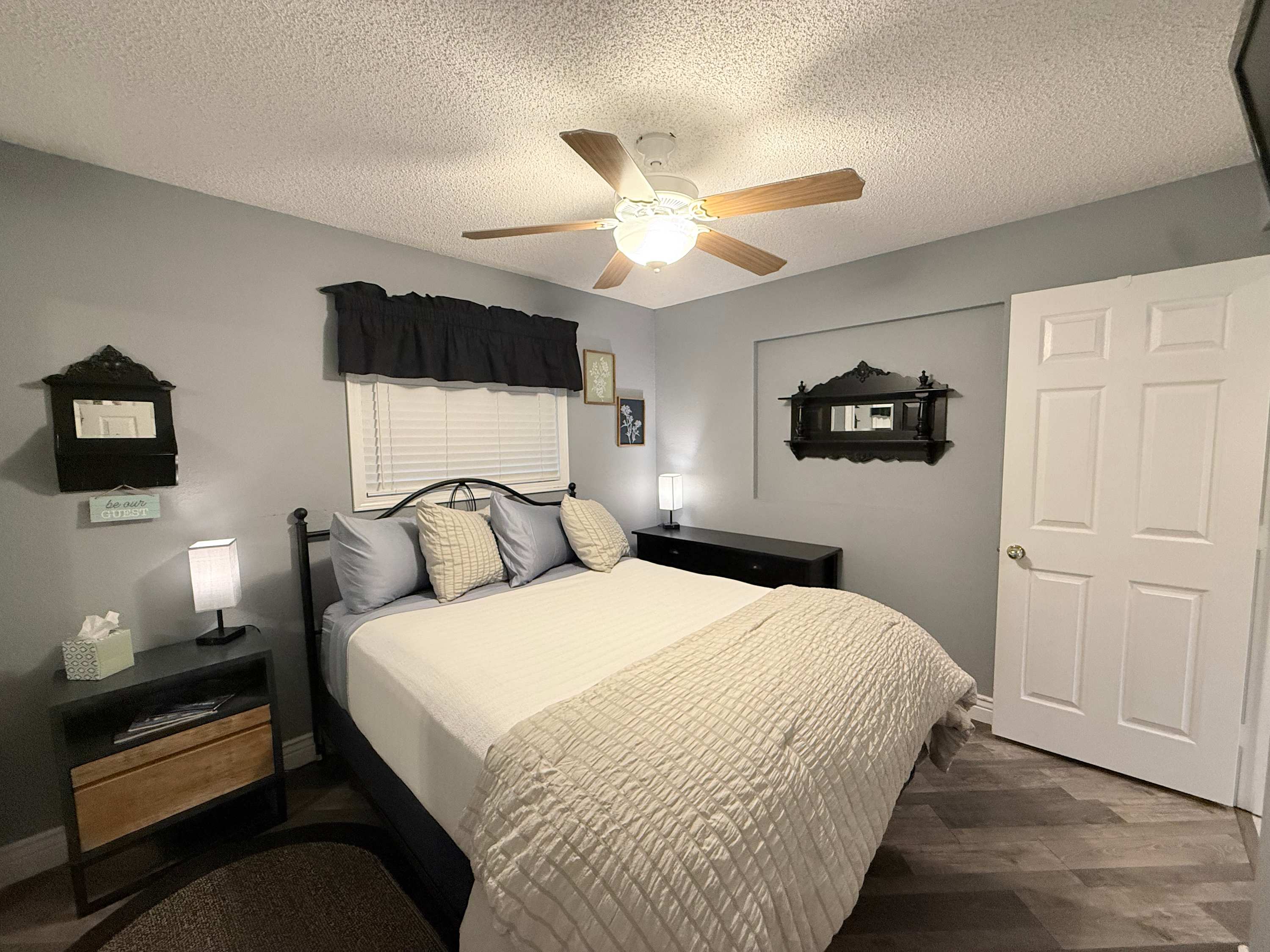 The bedroom retreat showcases a plush queen bed, ensuite bath, & TV​