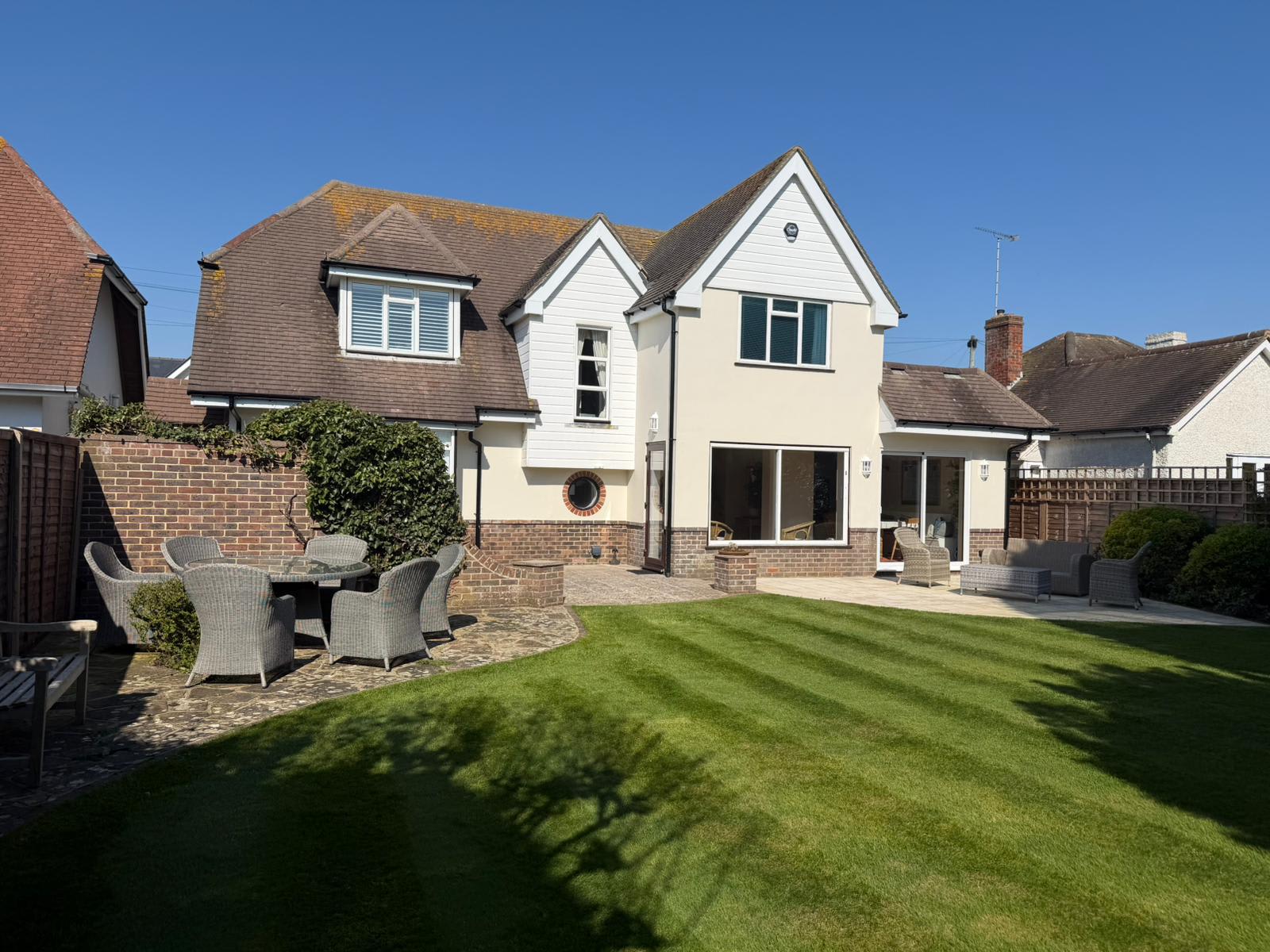 The rear of the property with its large back garden and patio area.
