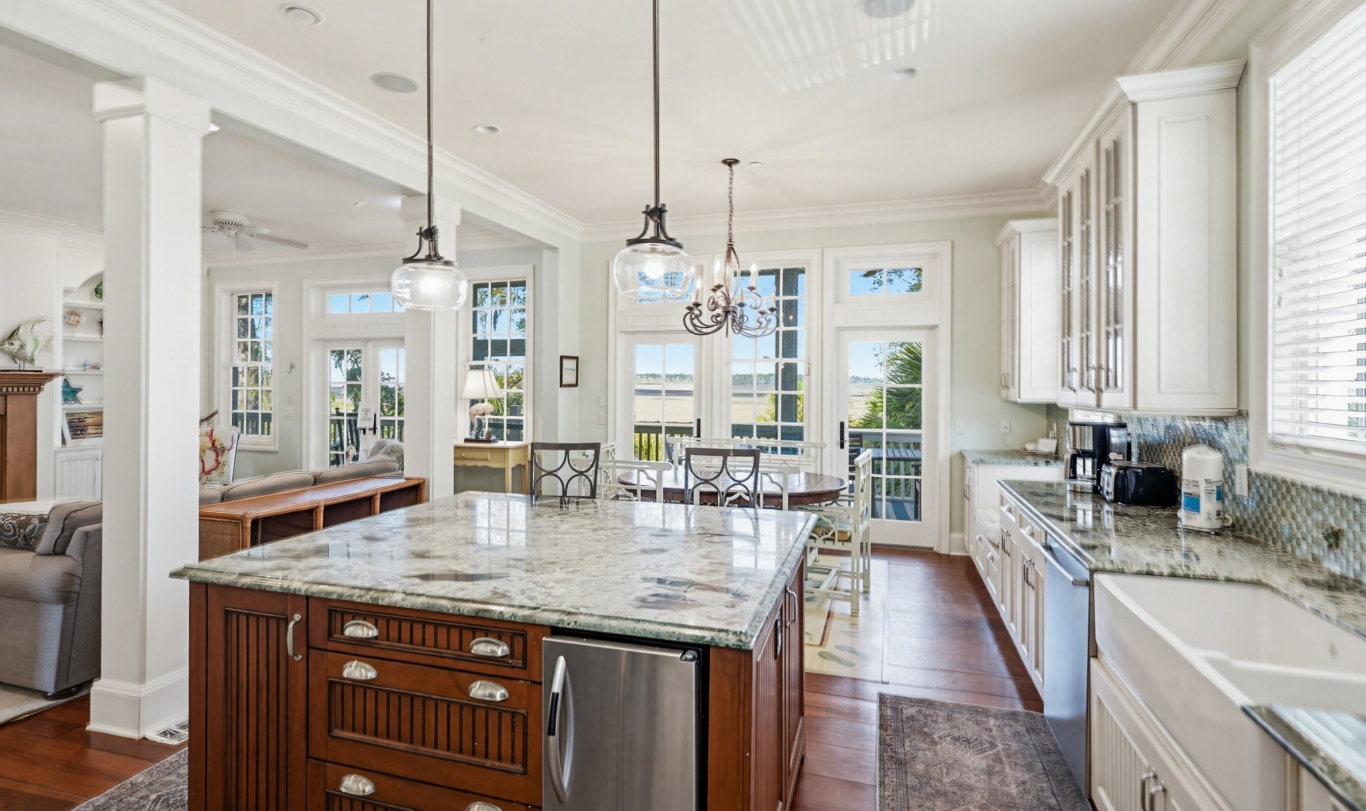 Kitchen with Island Bar, Dining Area and Access to Back Screened Porch