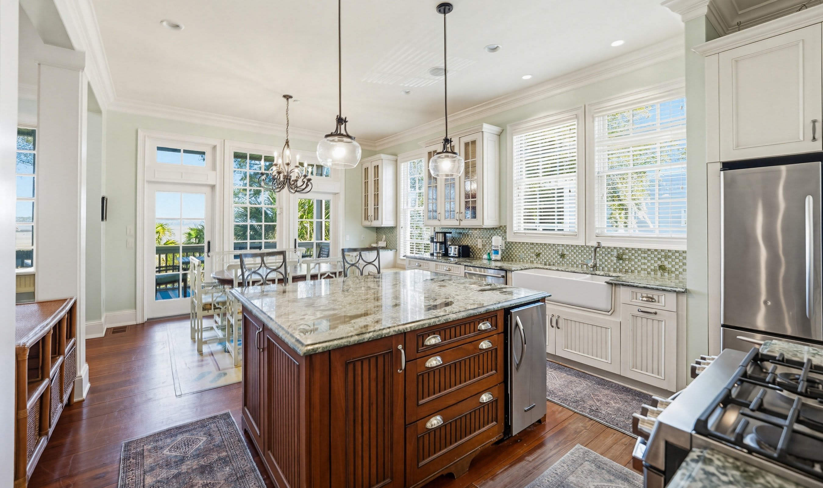 Kitchen with Island Bar, Dining Area and Access to Back Screened Porch