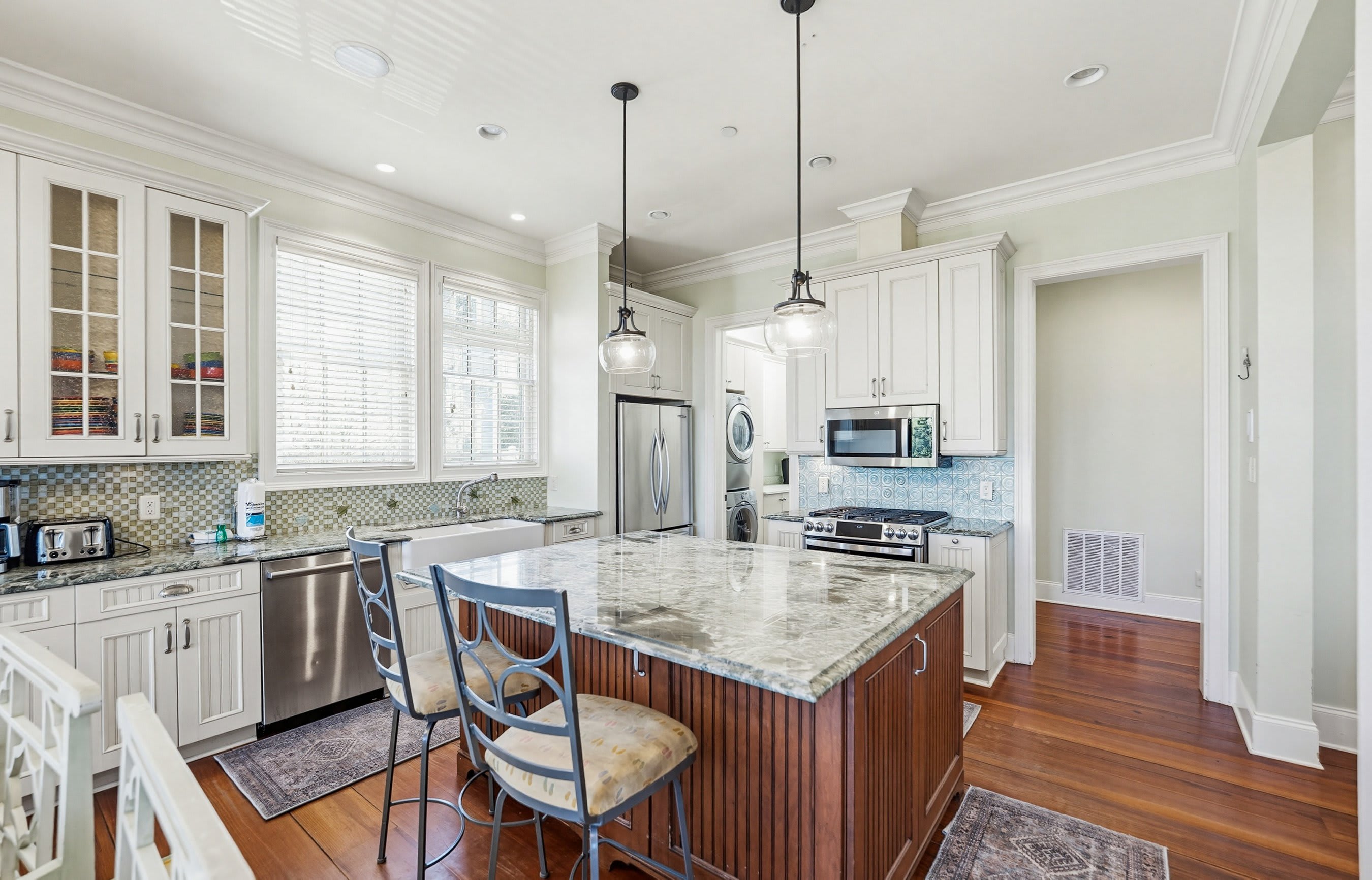 Kitchen with Island Bar, Dining Area and Full Pantry with Washer and Dryer