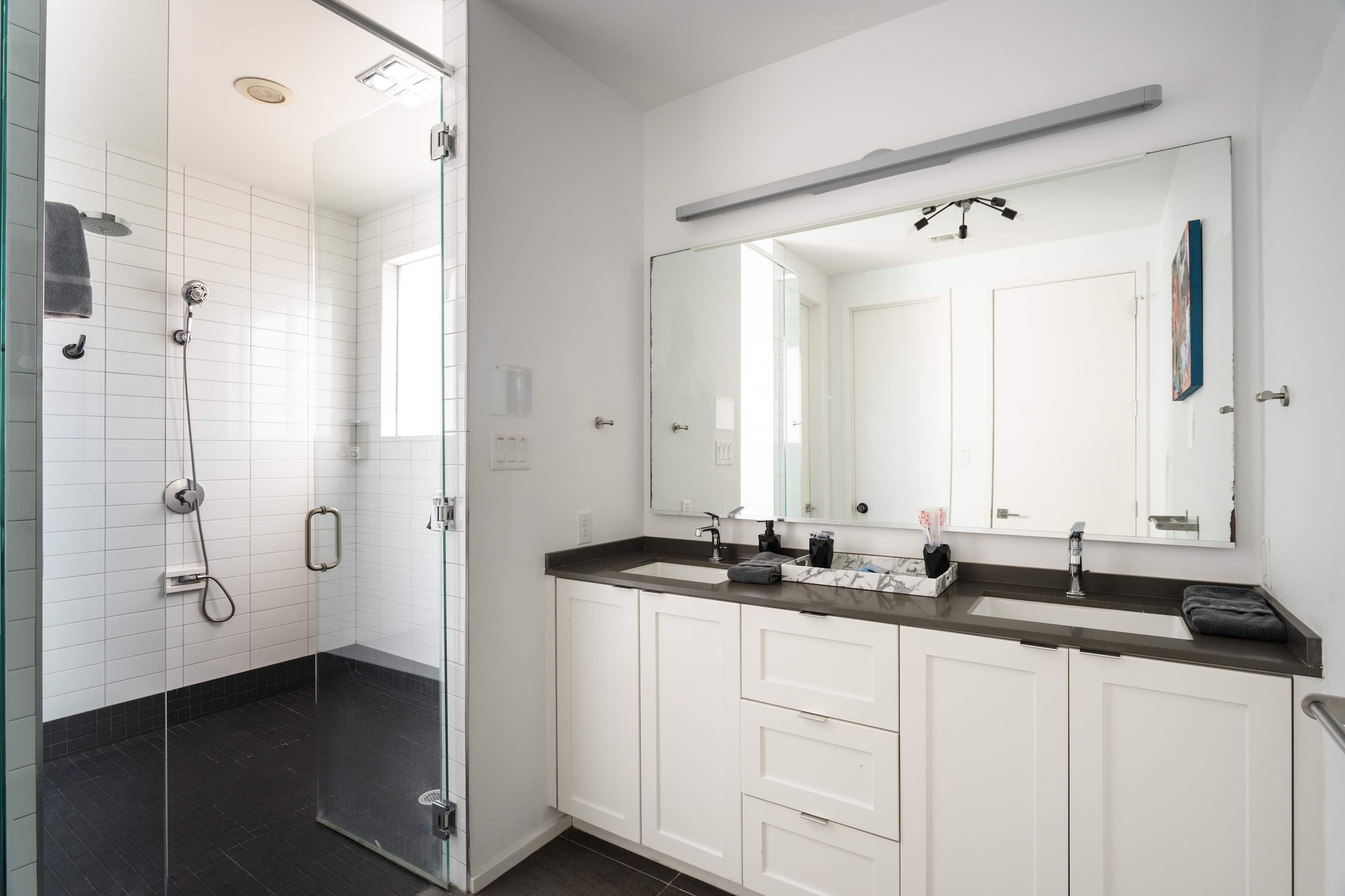Bright Bathroom With A Walk-In Shower, And Double Vanity