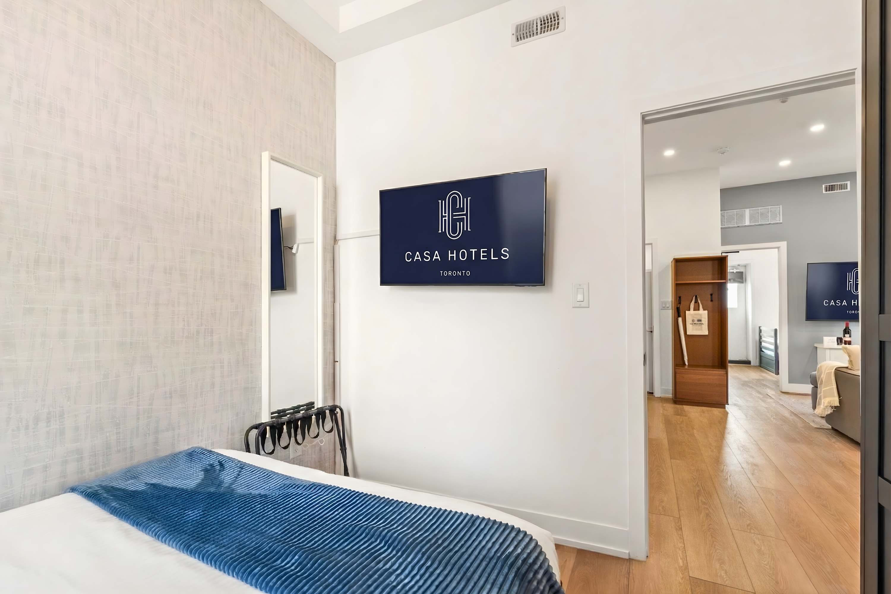 Bedroom 2 featuring a large Smart TV and direct view to the main living area.