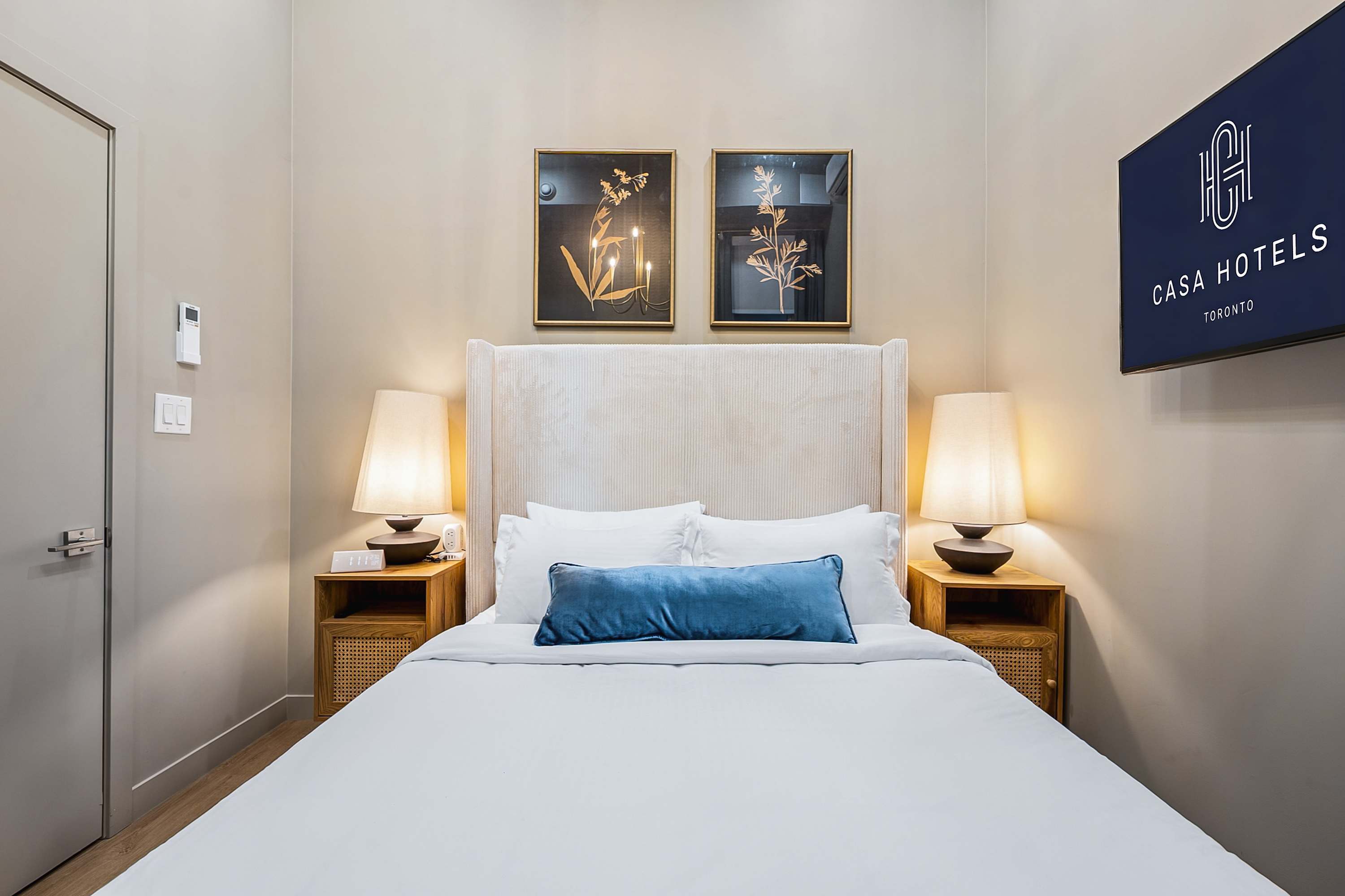 Serene bedroom with a plush queen bed and a smart TV.
