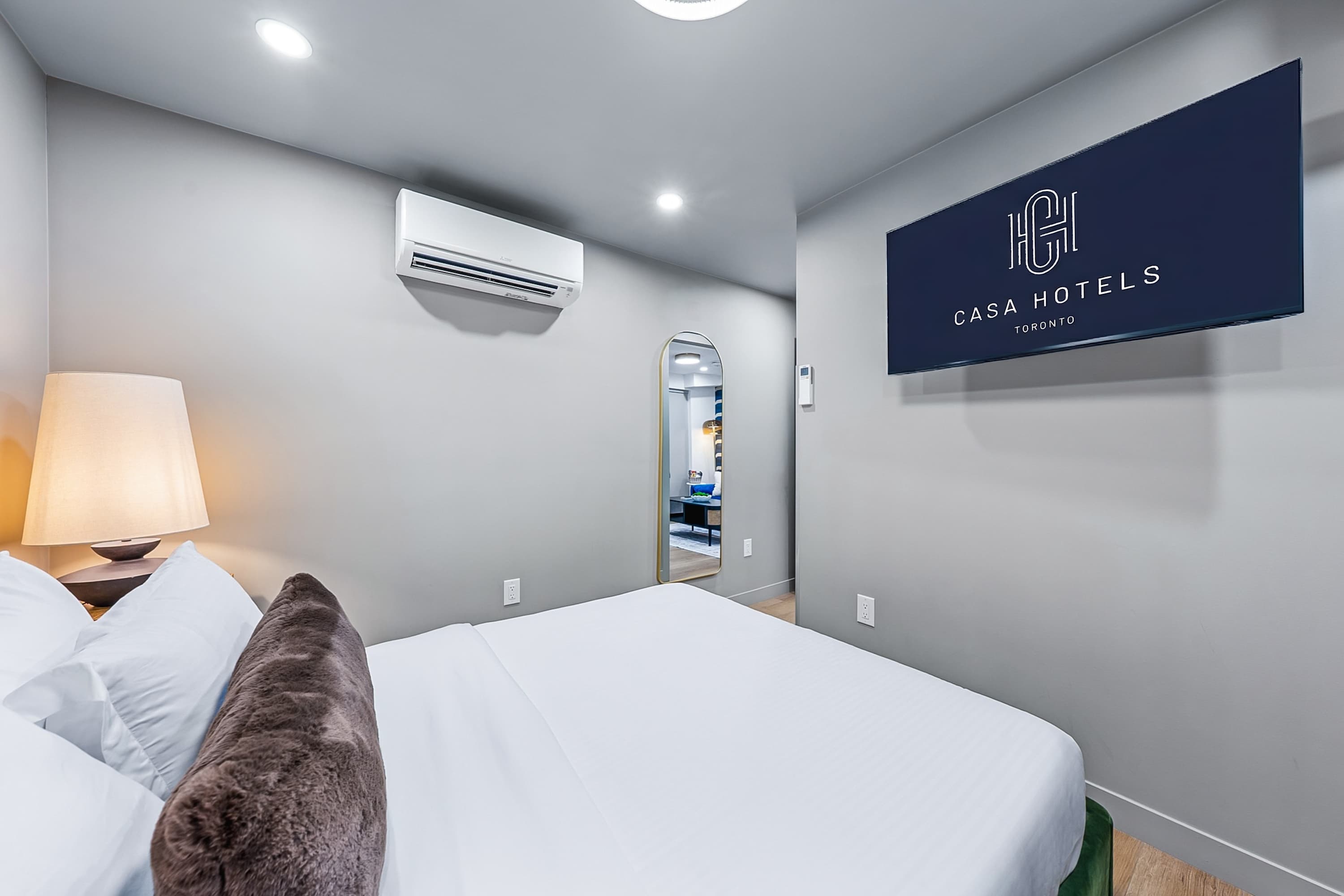 A serene bedroom designed for deep rest, movie nights and relaxation with an A/C.