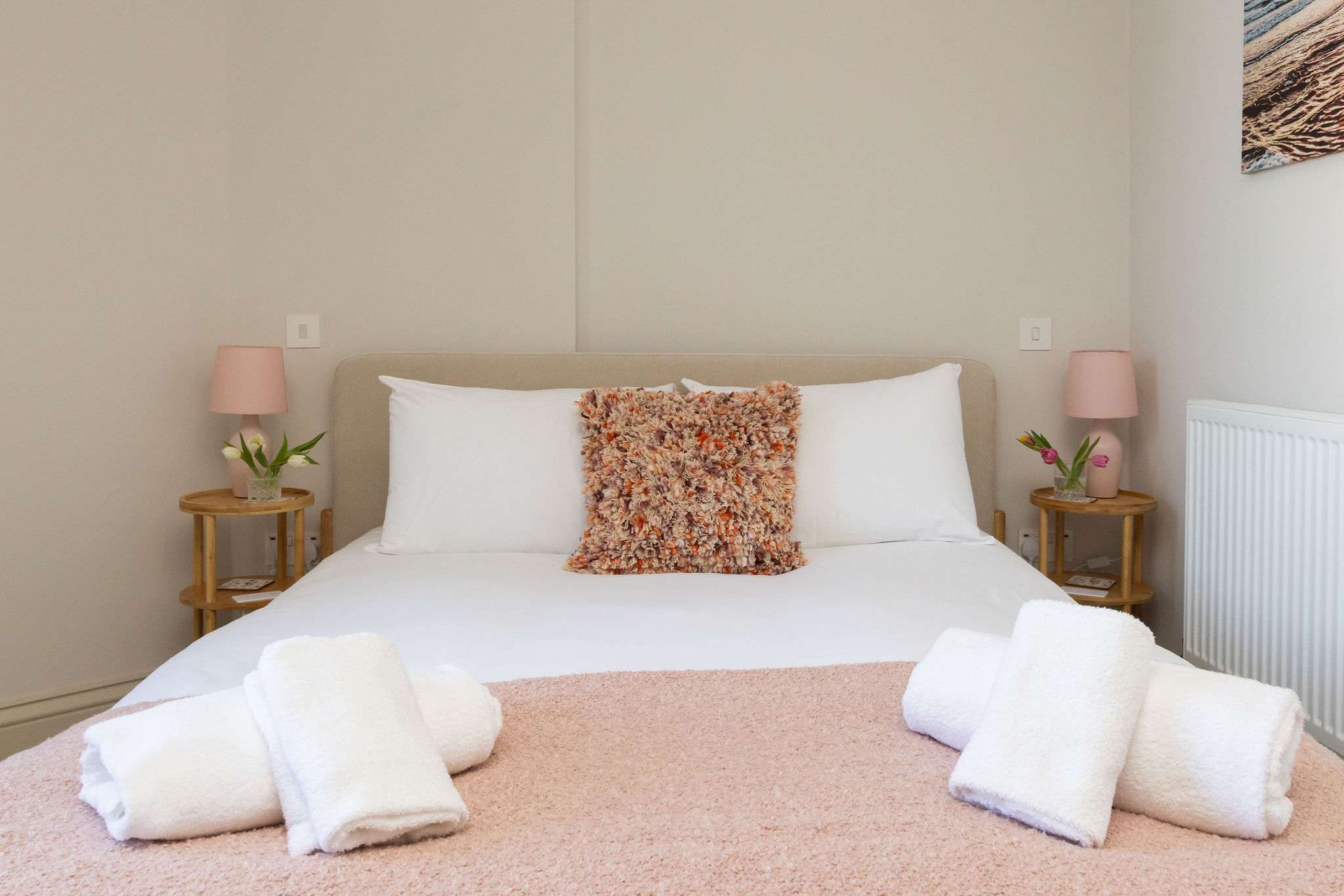 Peaceful bedrooms with quality linens offer a restful stay after days on the coast.