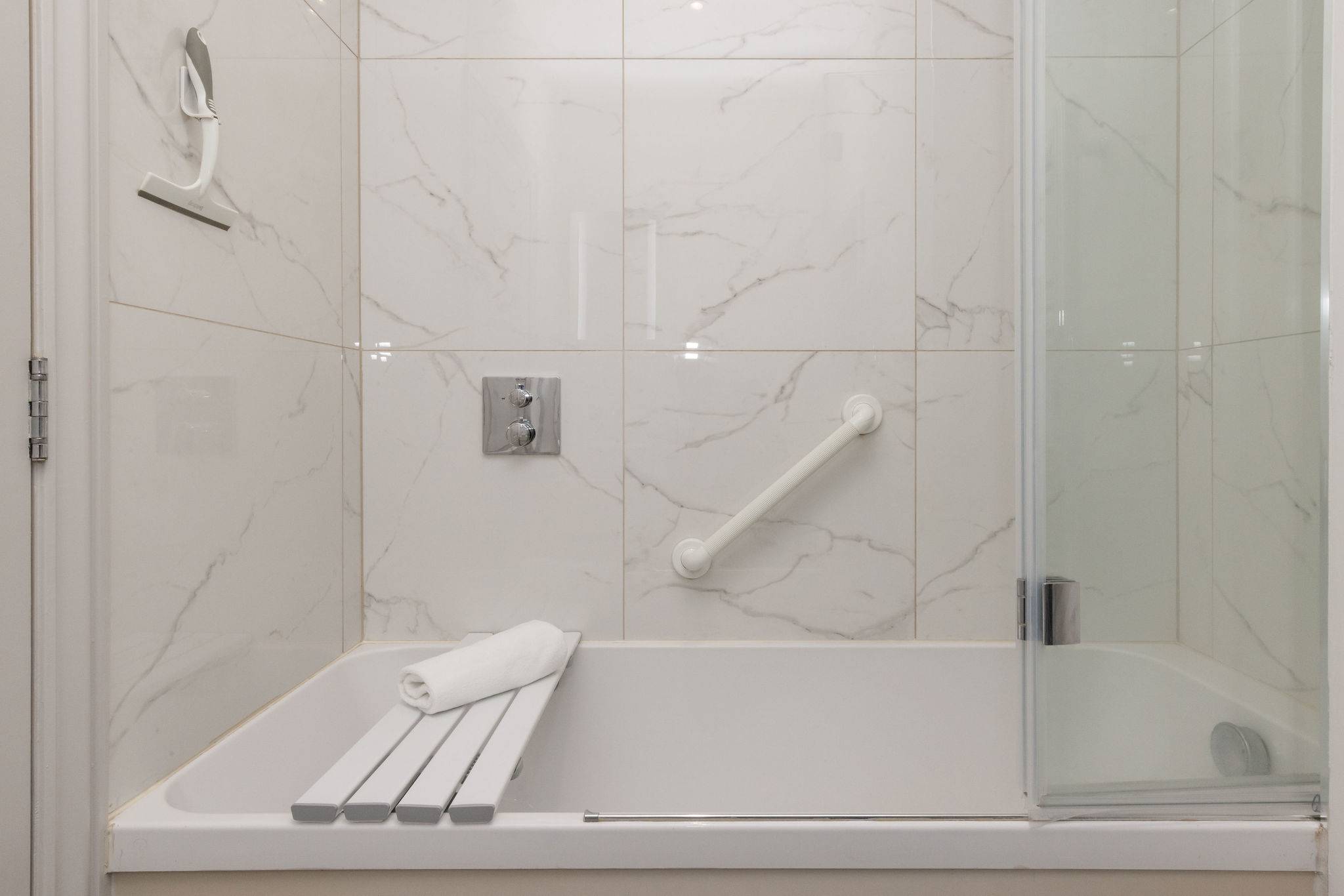 Fresh, modern bathrooms add comfort and ease to this relaxing stay by the sea.