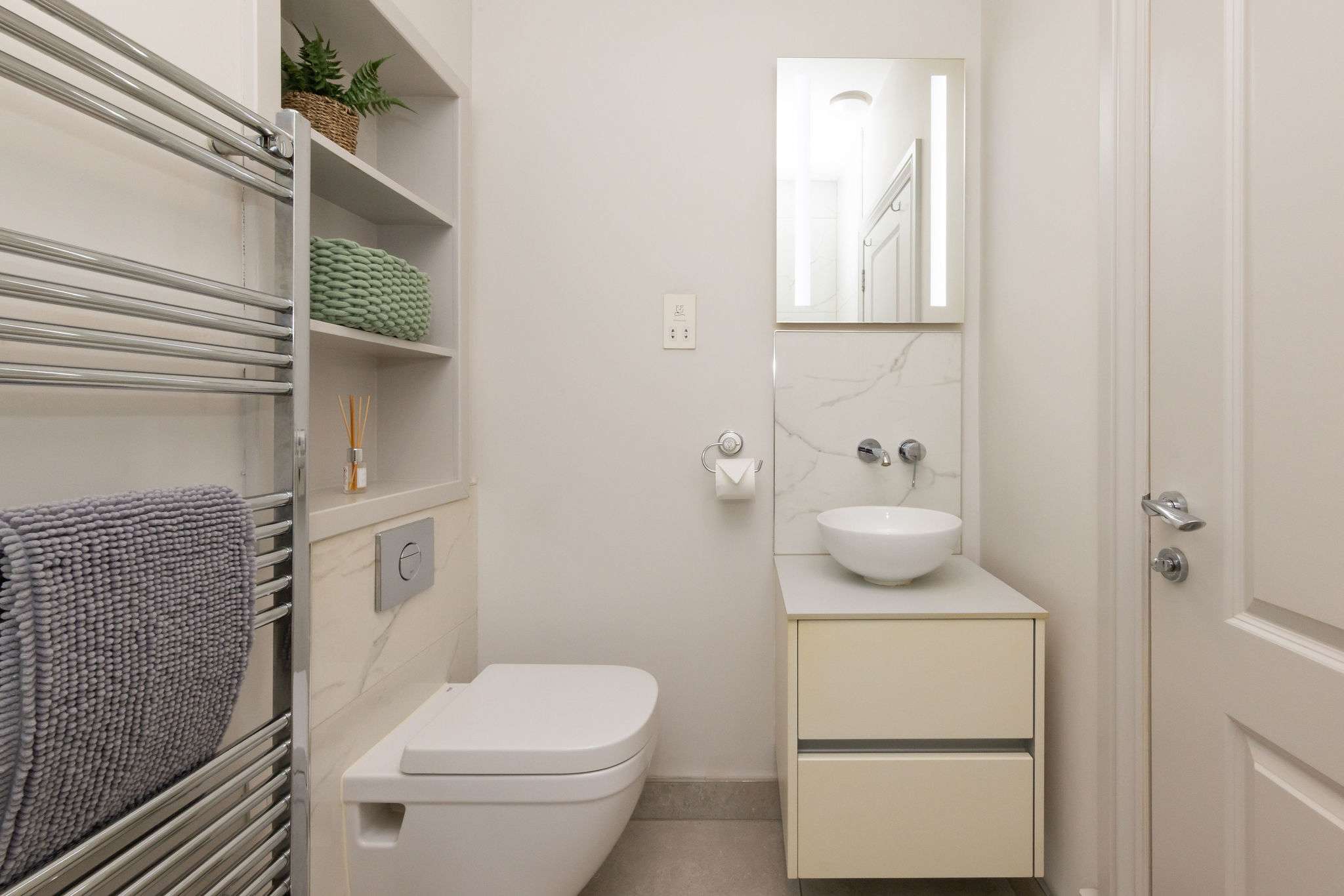 Modern bathroom spaces bring style and convenience to this seafront apartment.