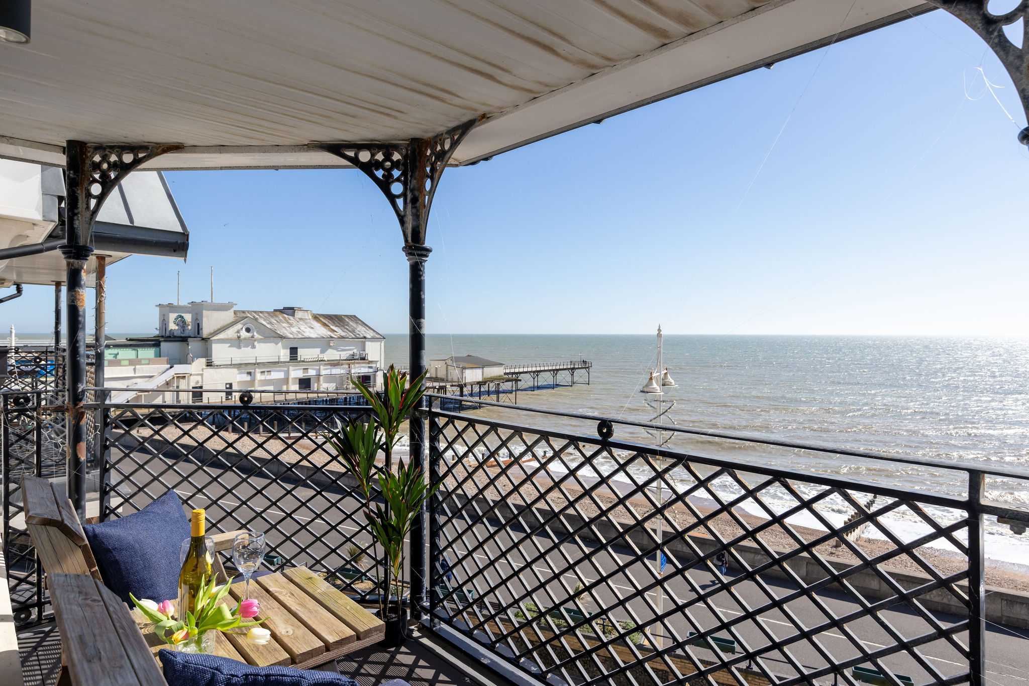 Sweeping coastal views make this stylish apartment a standout choice for a seaside escape.