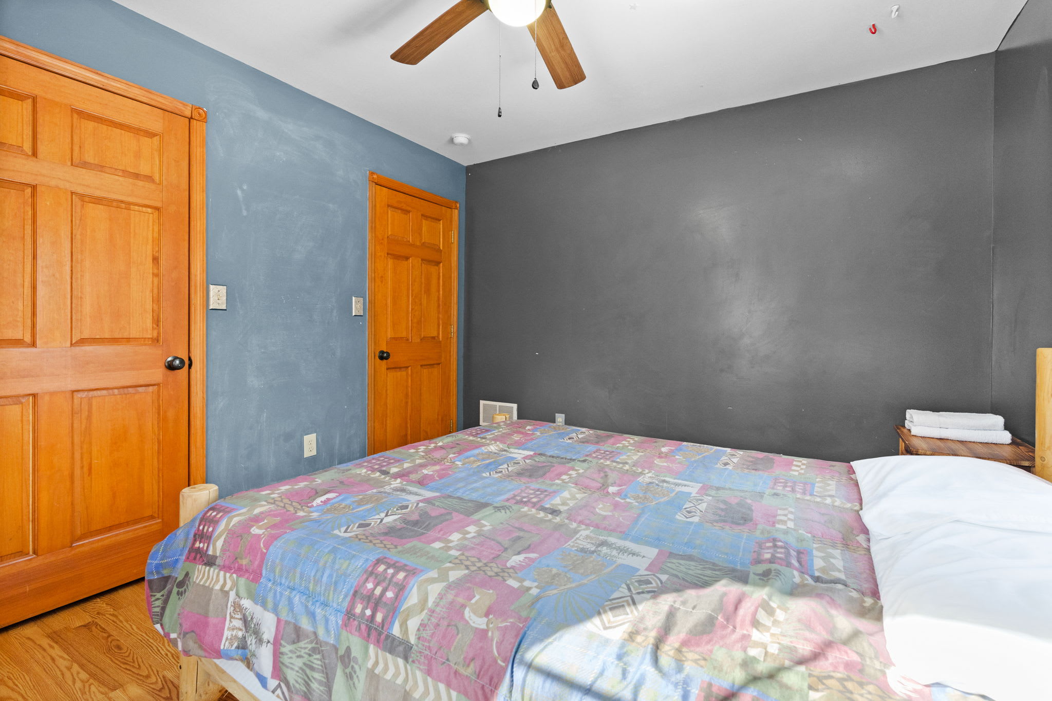 Cozy bedroom with quilt and warm cabin charm