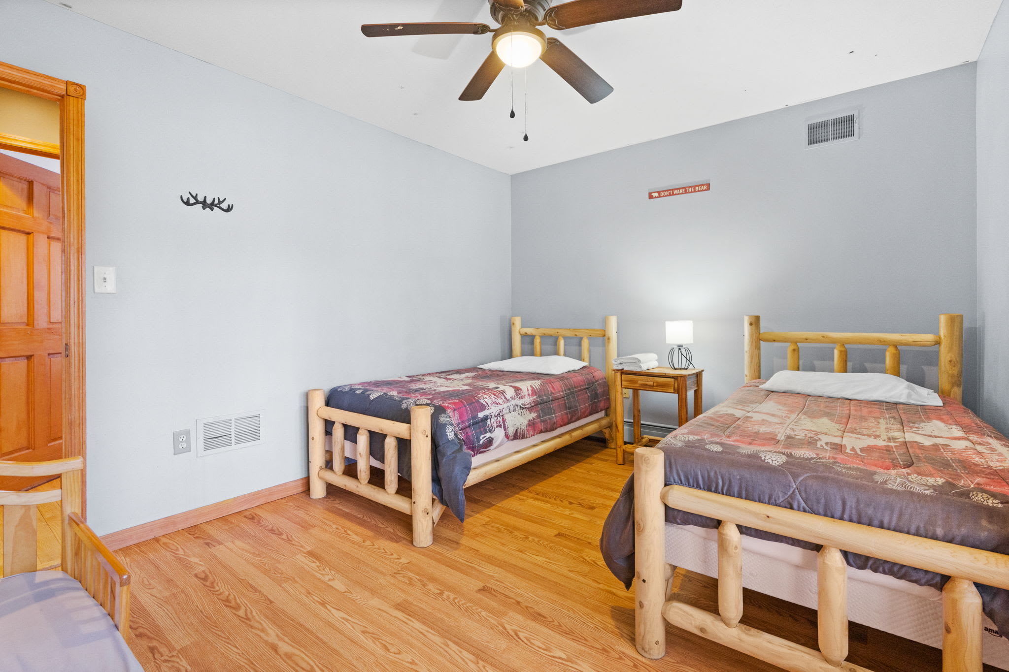 Beds with rustic log frames and cabin-themed bedding for a restful night